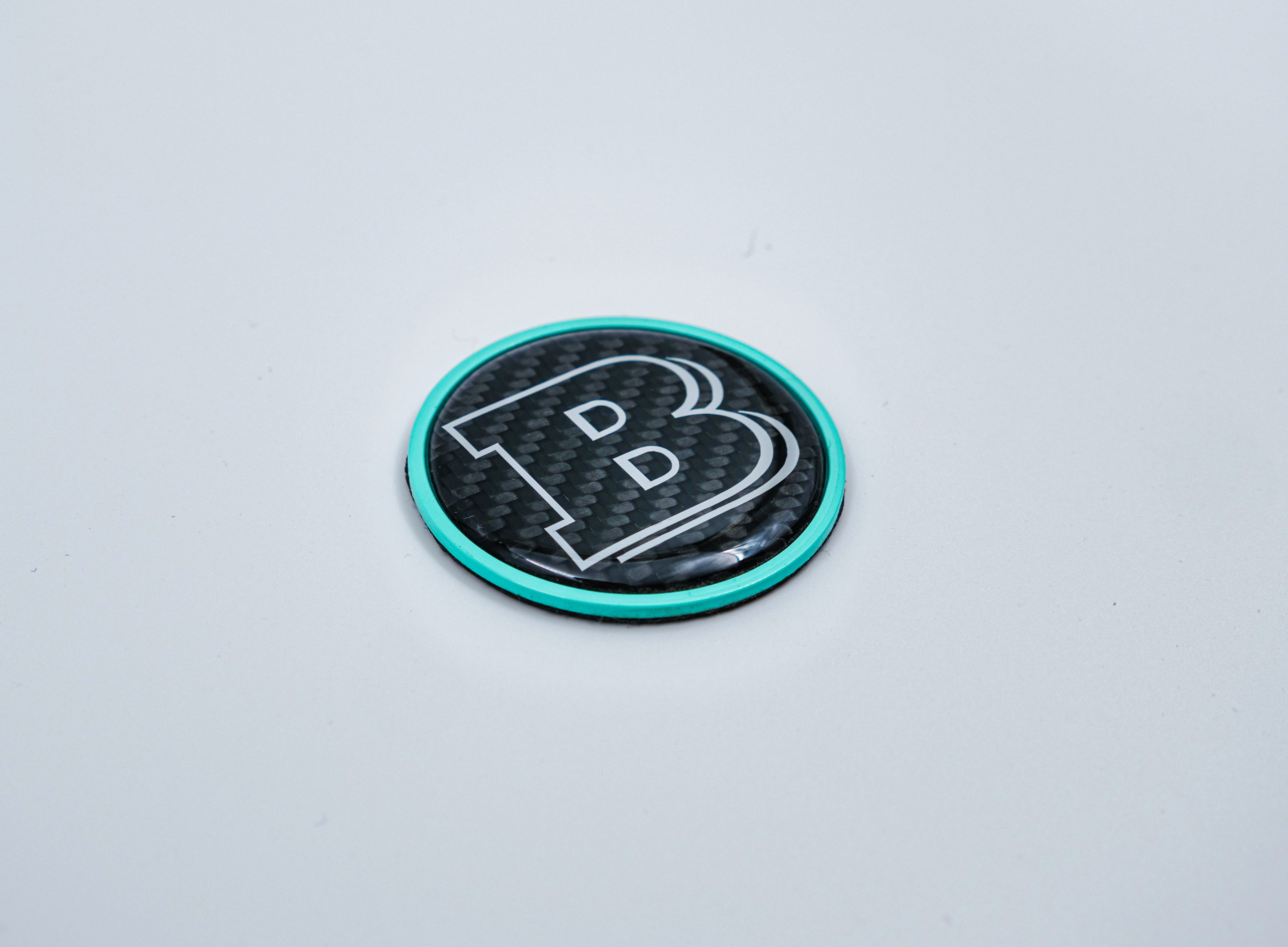 2-component metal carbon Tiffany blue Brabus badge logo emblem 55mm for hood scoop of Mercedes-Benz W463, W463A, W464 G-Class.