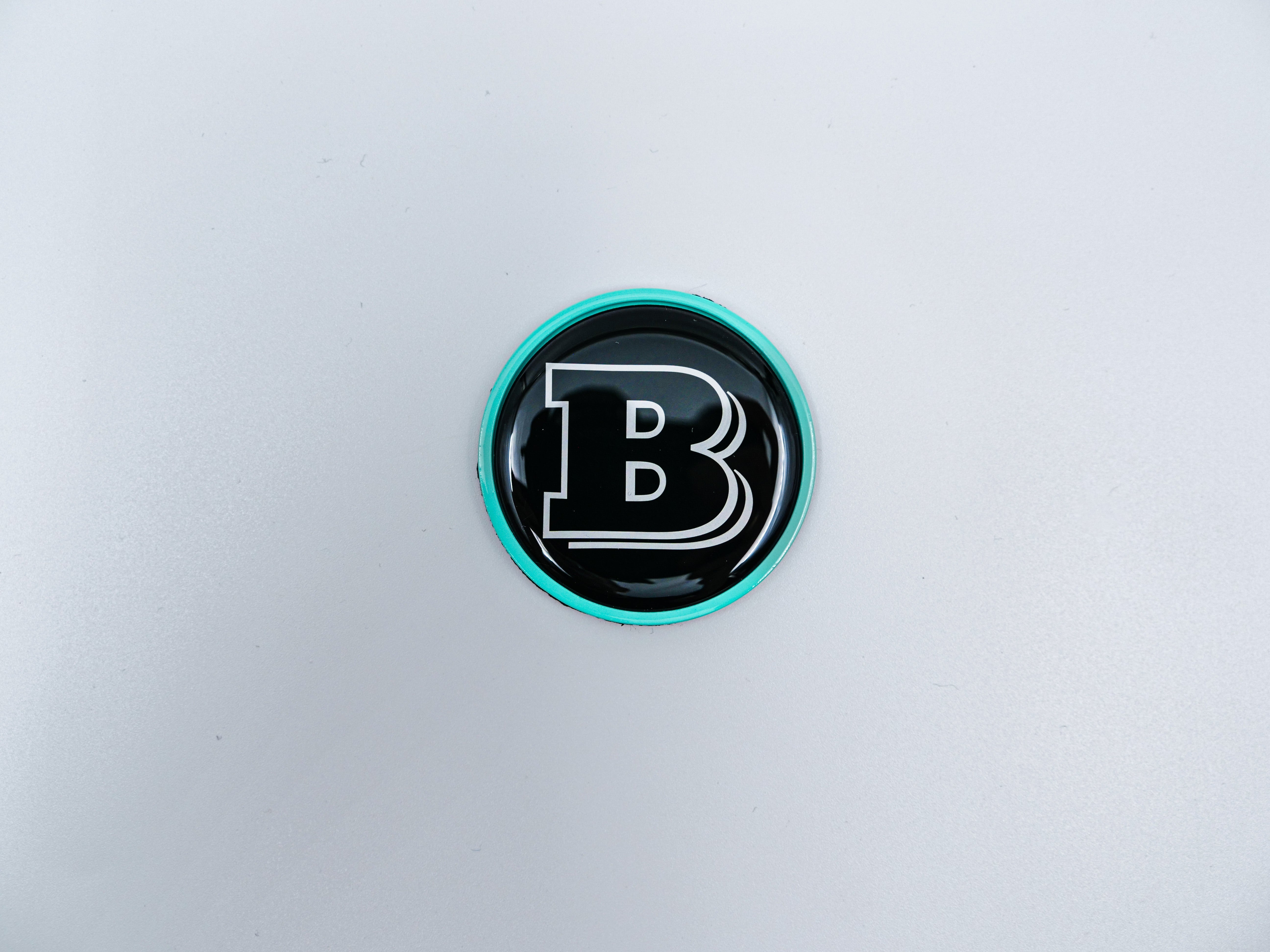 2-component metal Tiffany blue Brabus badge logo emblem 55mm for hood scoop of Mercedes-Benz W463, W463A, W464 G-Class.