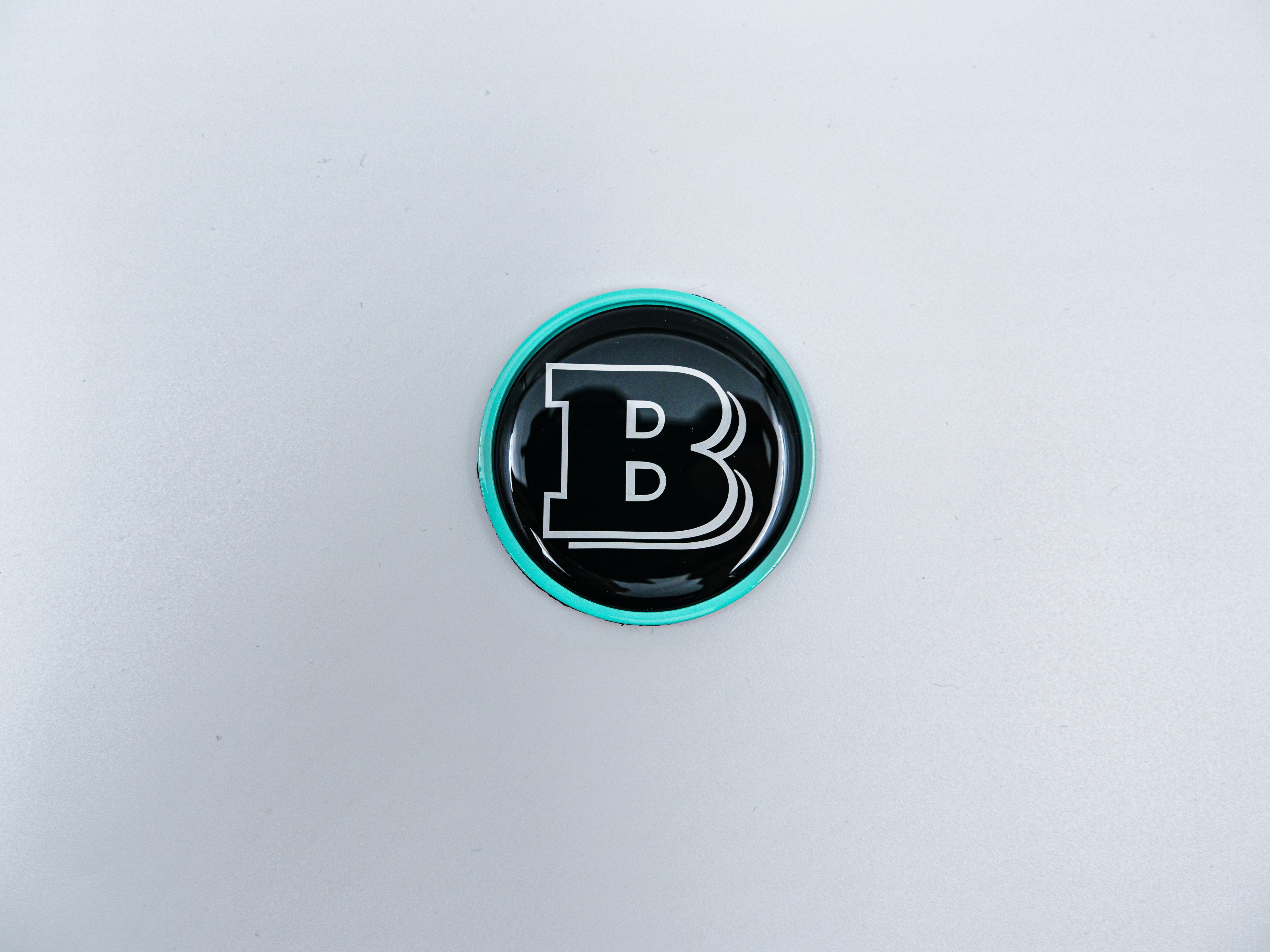 2-component metal Tiffany blue Brabus badge logo emblem 55mm for hood scoop of Mercedes-Benz W463, W463A, W464 G-Class - Custom Class