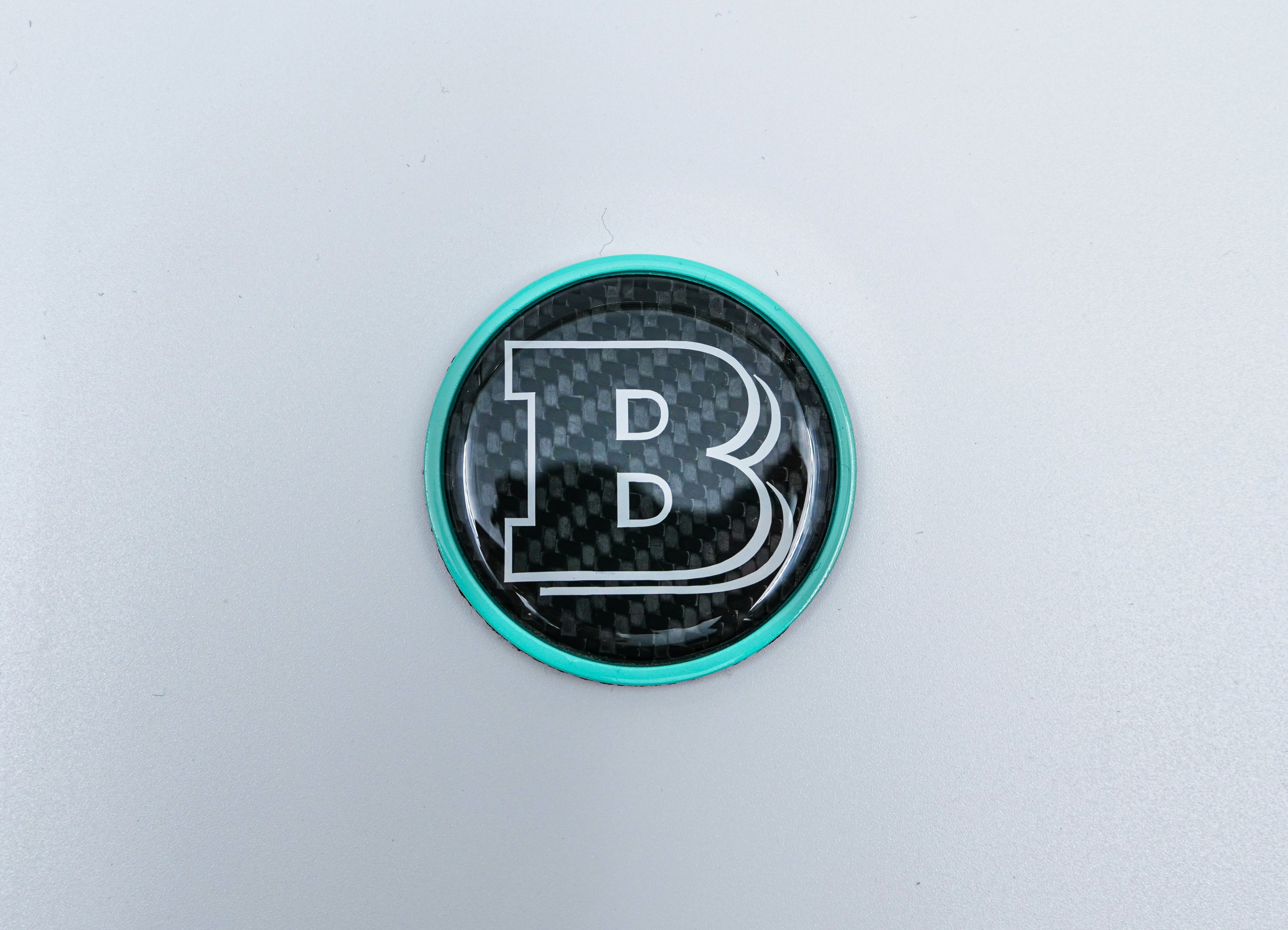 2-component metal carbon Tiffany blue Brabus badge logo emblem 55mm for hood scoop of Mercedes-Benz W463, W463A, W464 G-Class - Custom Class