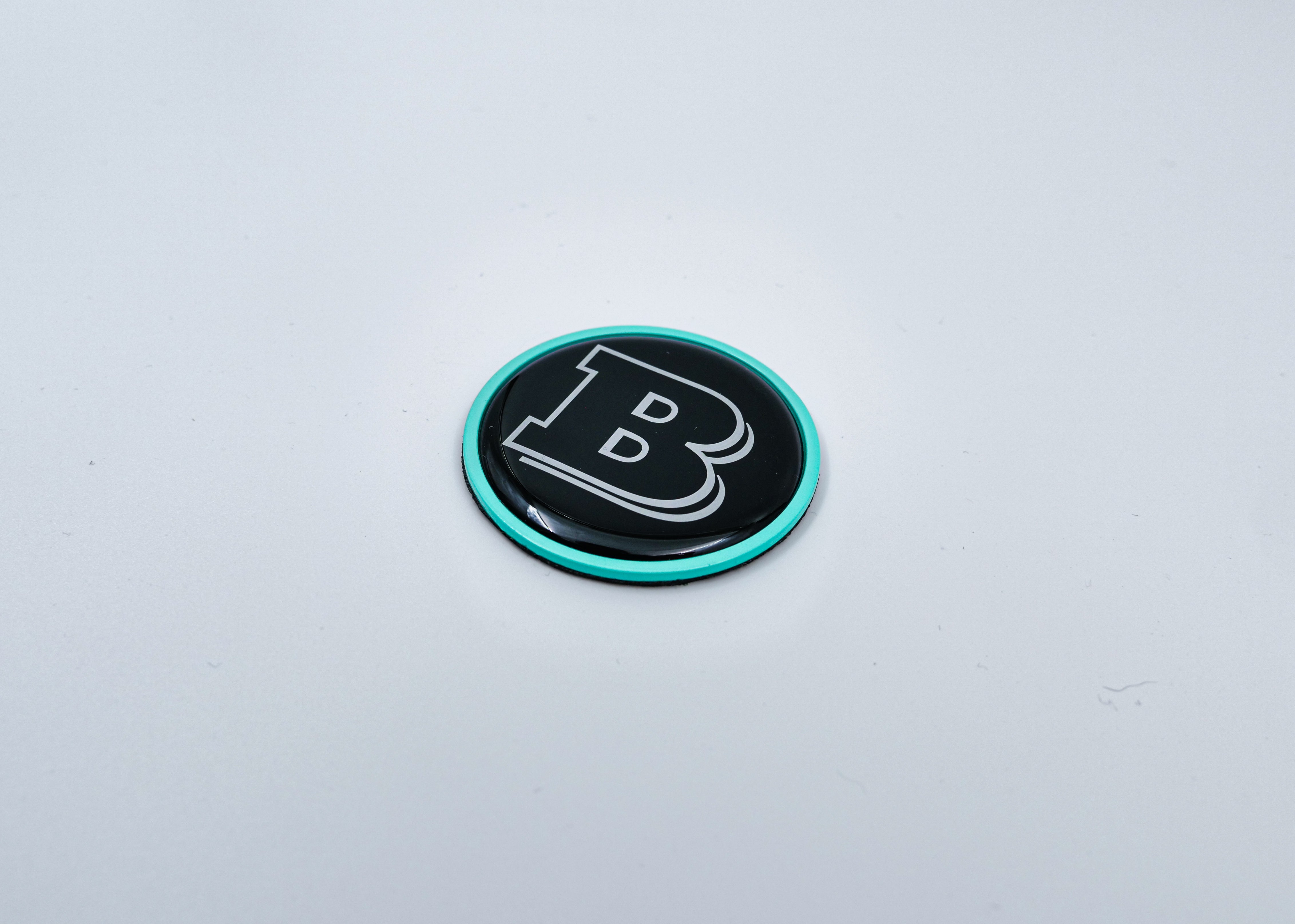 2-component metal Tiffany blue Brabus badge logo emblem 55mm for hood scoop of Mercedes-Benz W463, W463A, W464 G-Class - Custom Class