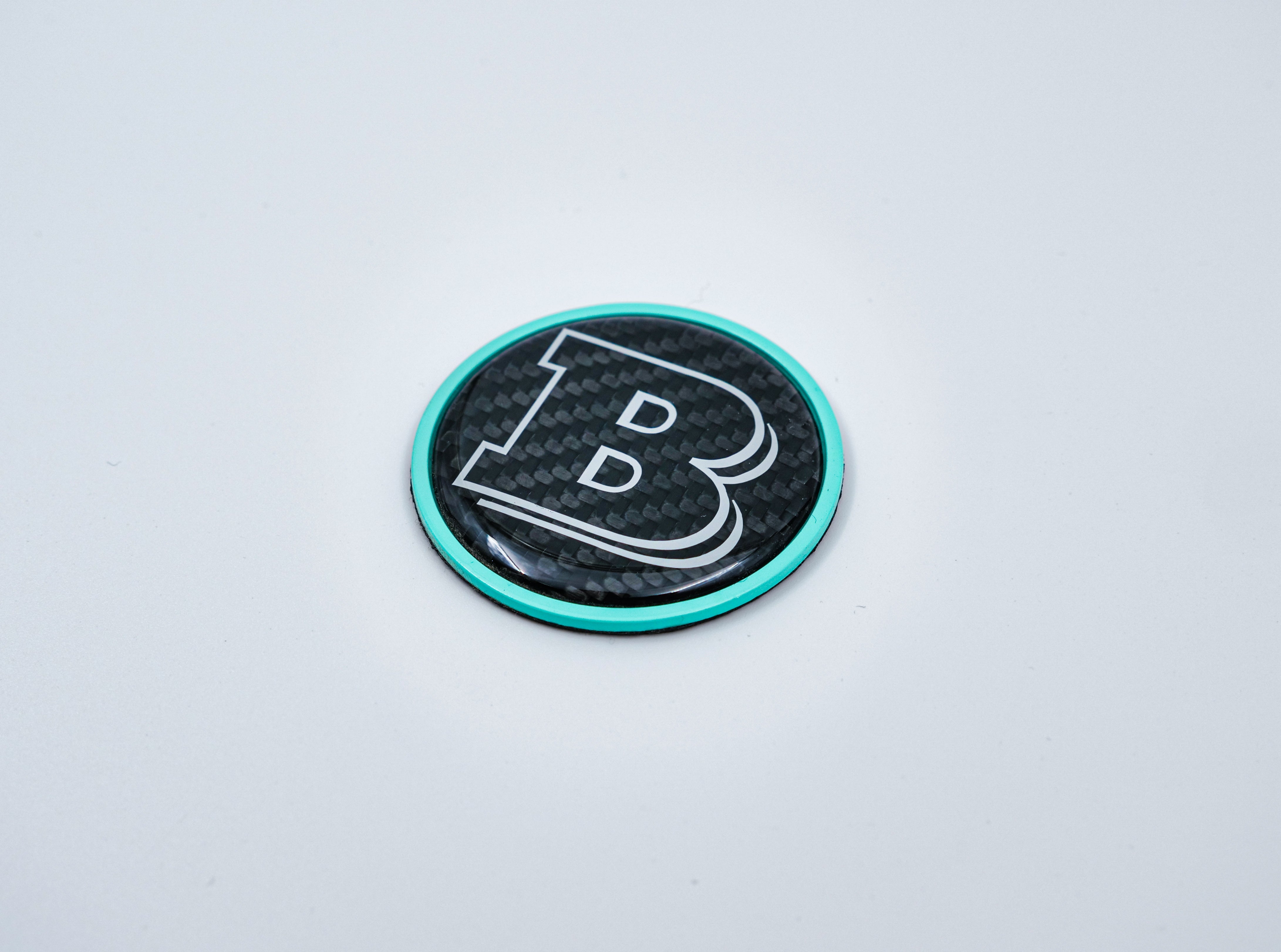 2-component metal carbon Tiffany blue Brabus badge logo emblem 55mm for hood scoop of Mercedes-Benz W463, W463A, W464 G-Class - Custom Class