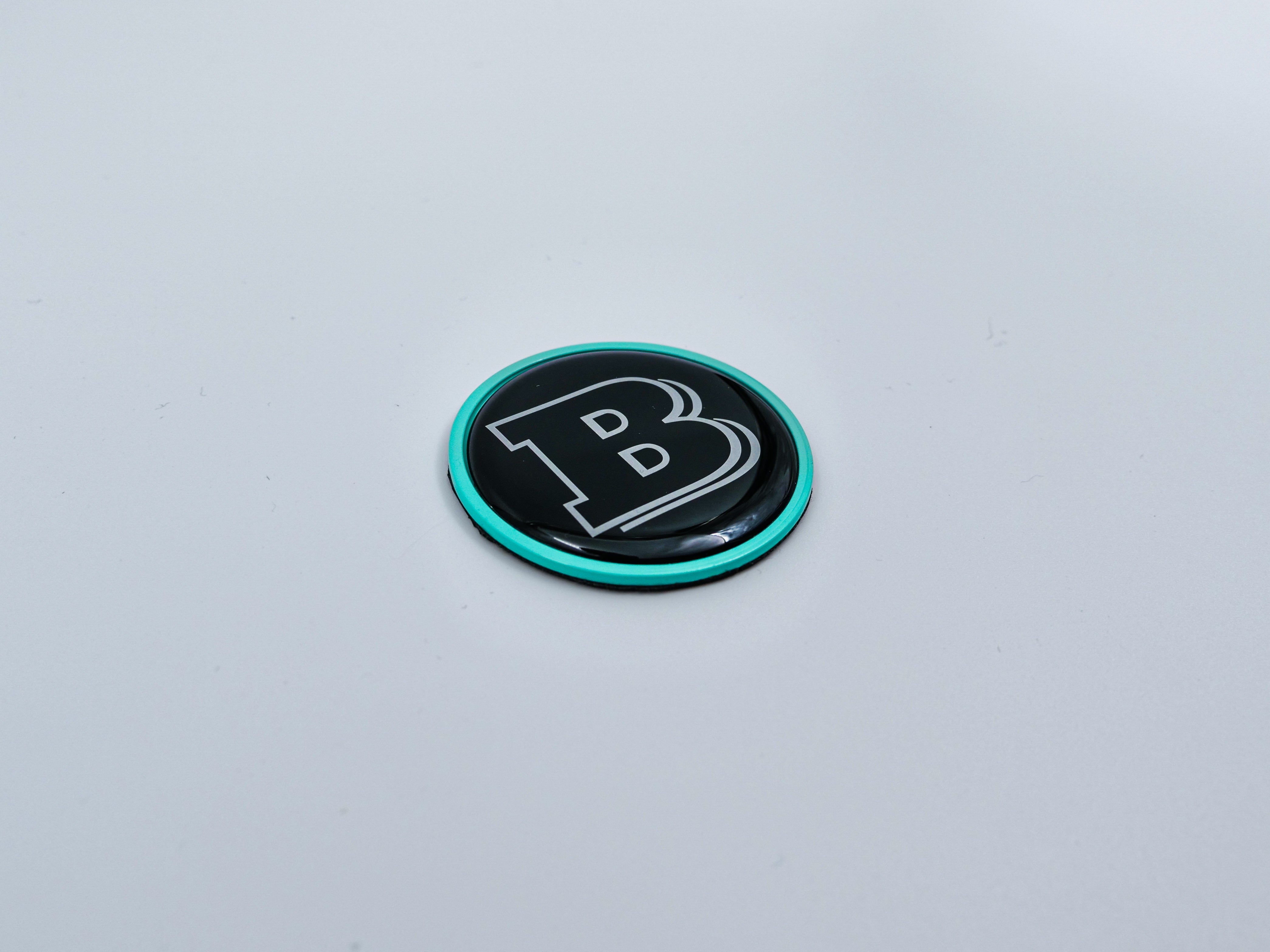 2-component metal Tiffany blue Brabus badge logo emblem 55mm for hood scoop of Mercedes-Benz W463, W463A, W464 G-Class - Custom Class