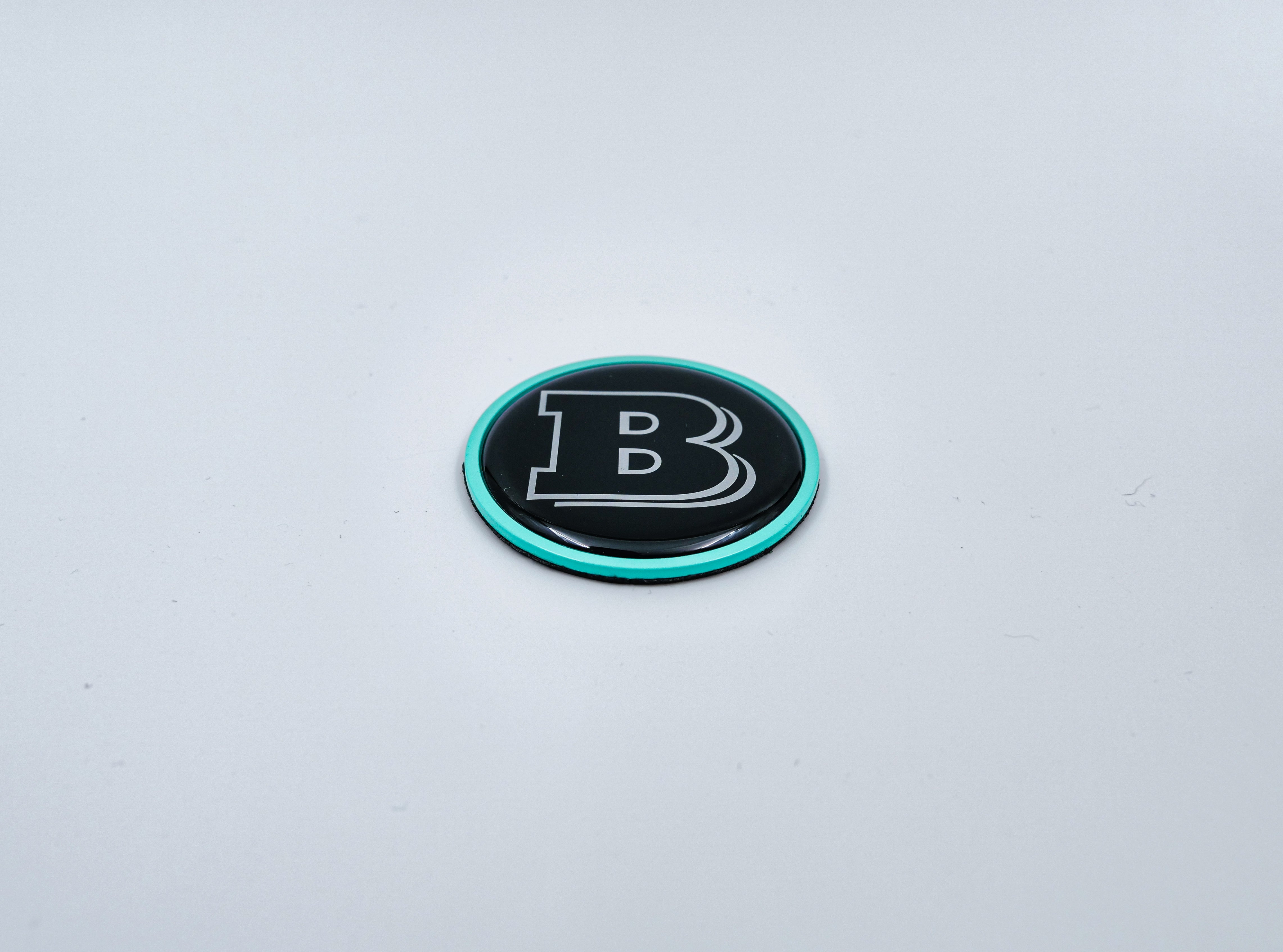 2-component metal Tiffany blue Brabus badge logo emblem 55mm for hood scoop of Mercedes-Benz W463, W463A, W464 G-Class - Custom Class