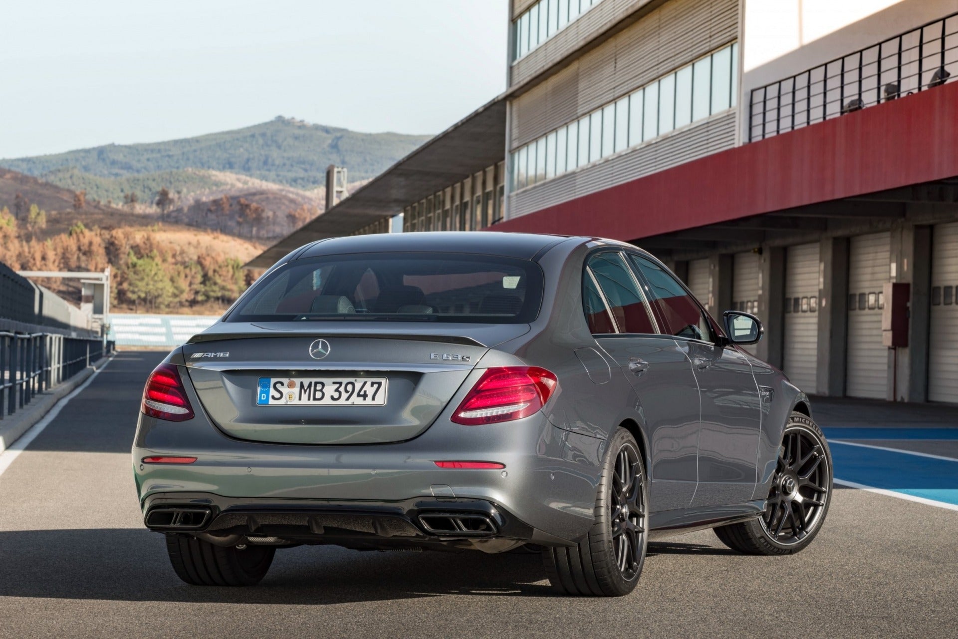 AMG E63 style bodykit for Mercedes E-Class W213 (2016+), complete with front bumper, diffuser, grille, exhaust tips, and mounting components.