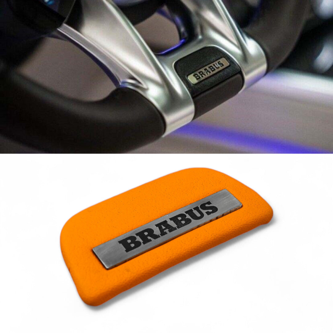 Brabus orange leather emblem insert for AMG steering wheel on Mercedes-Benz W463A W464 from Custom Class, crafted in high-quality orange leather.