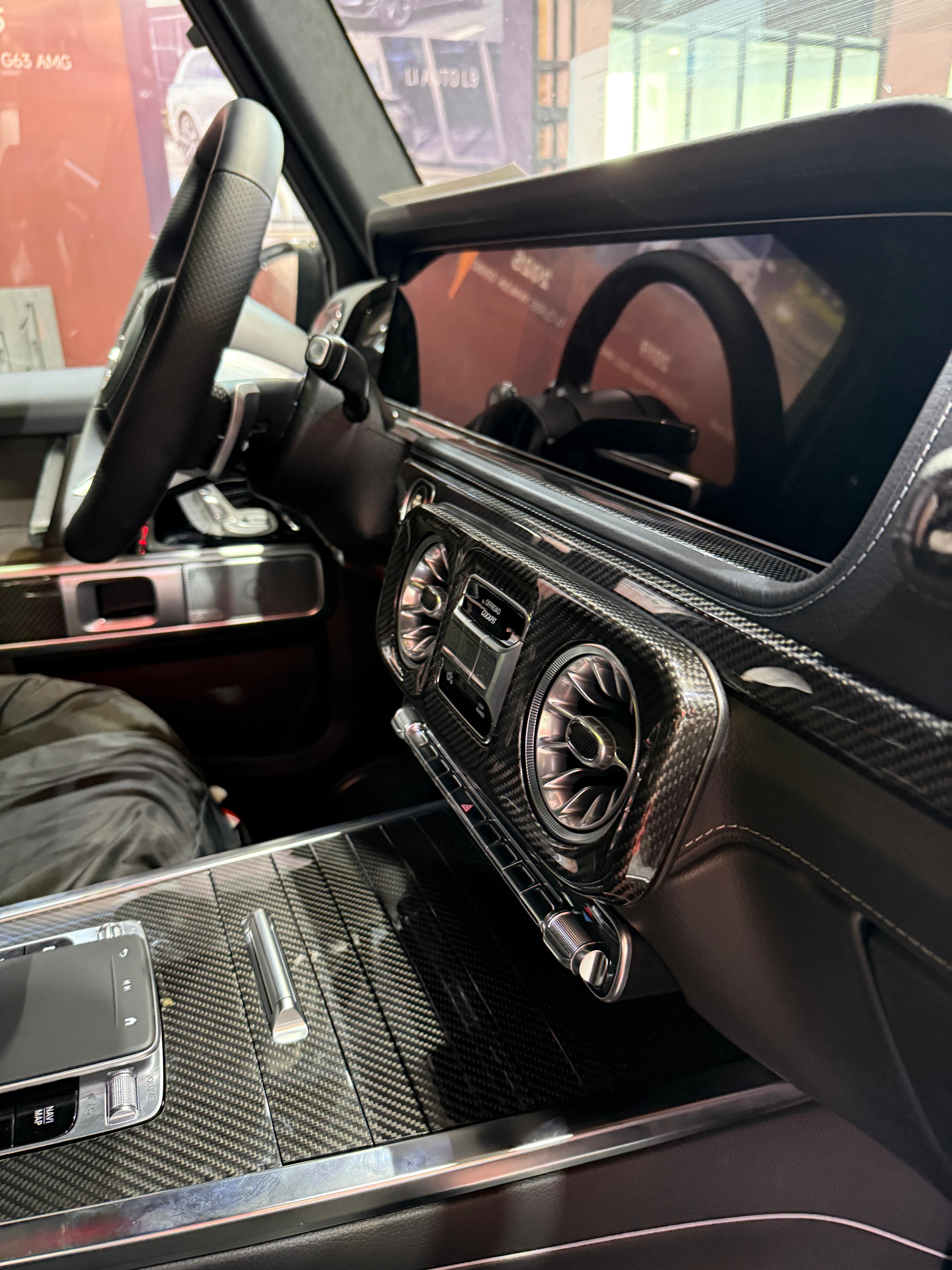 Carbon fiber interior trims for Mercedes G-Class W465 2024+ from Custom Class, featuring a sleek, glossy finish and premium fitment.