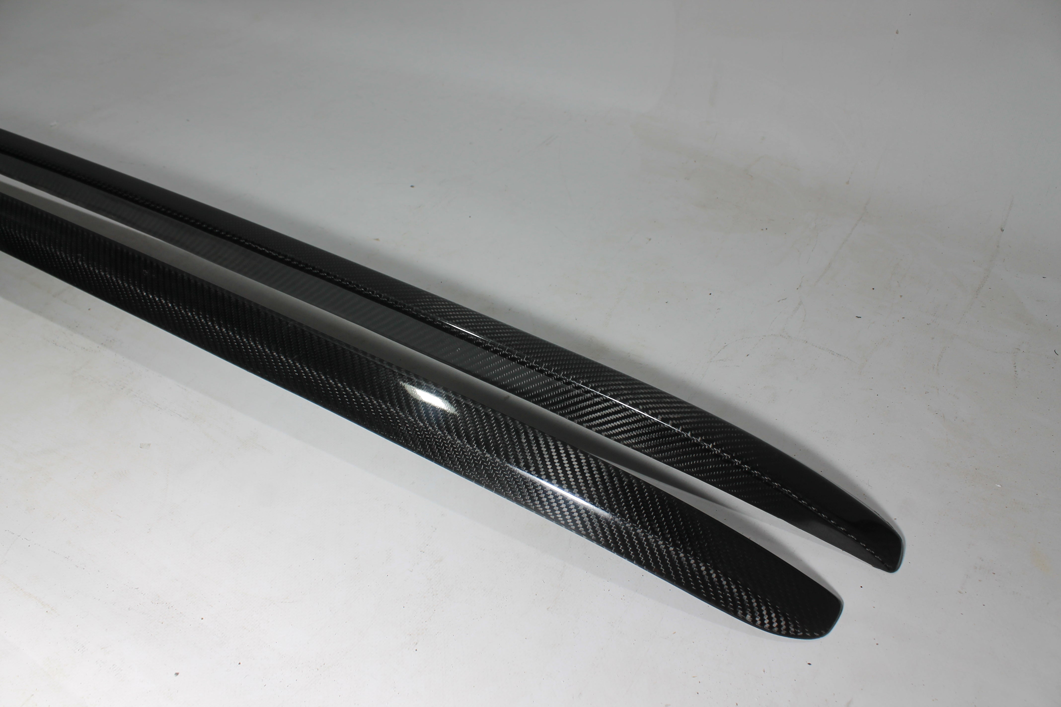 Carbon handrail (top trim) roof rails for Bentley Bentayga 2015-2018 from Custom Class, featuring genuine carbon fiber with a grey gloss UV-resistant finish.