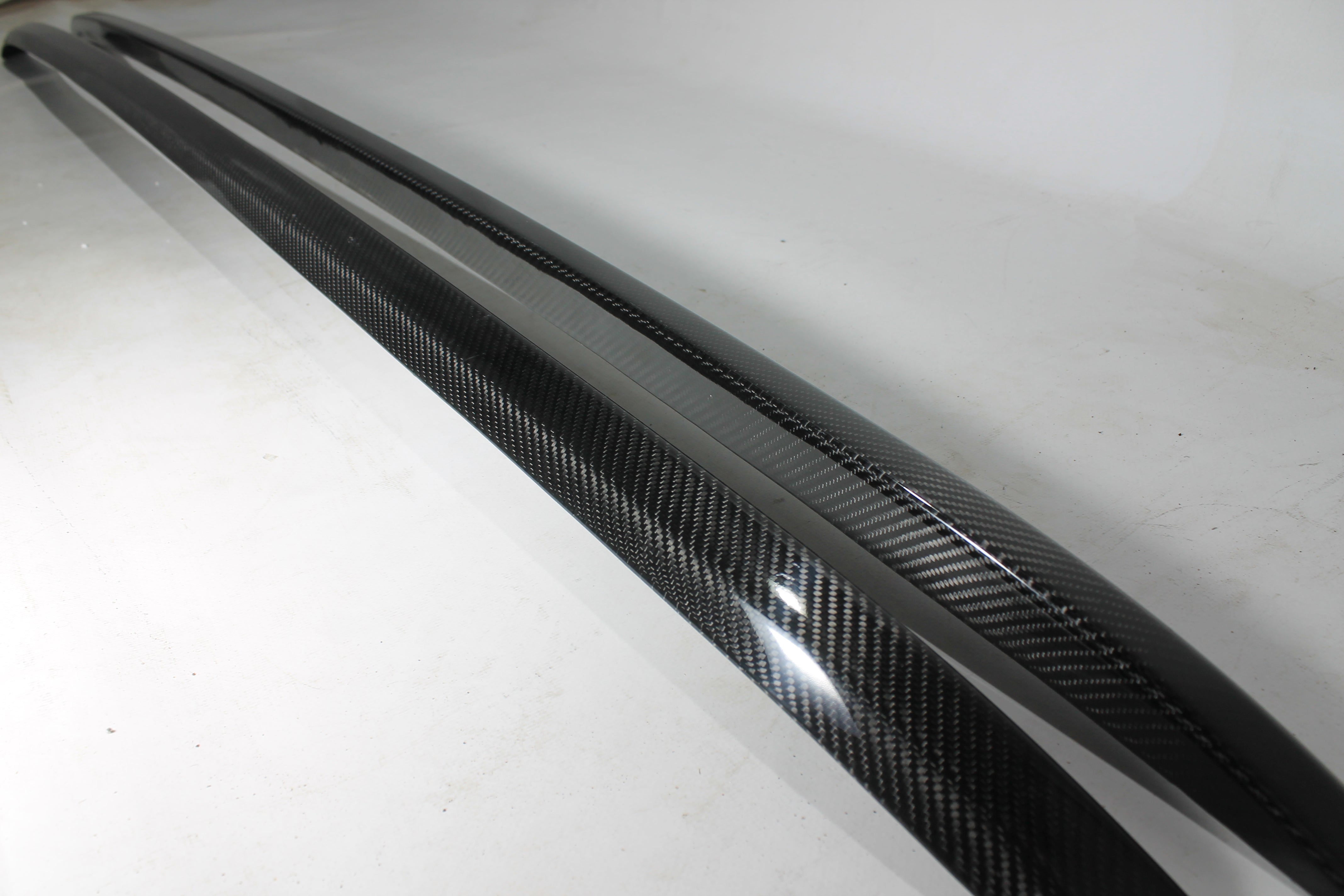 Carbon handrail (top trim) roof rails for Bentley Bentayga 2015-2018 from Custom Class, featuring genuine carbon fiber with a grey gloss UV-resistant finish.