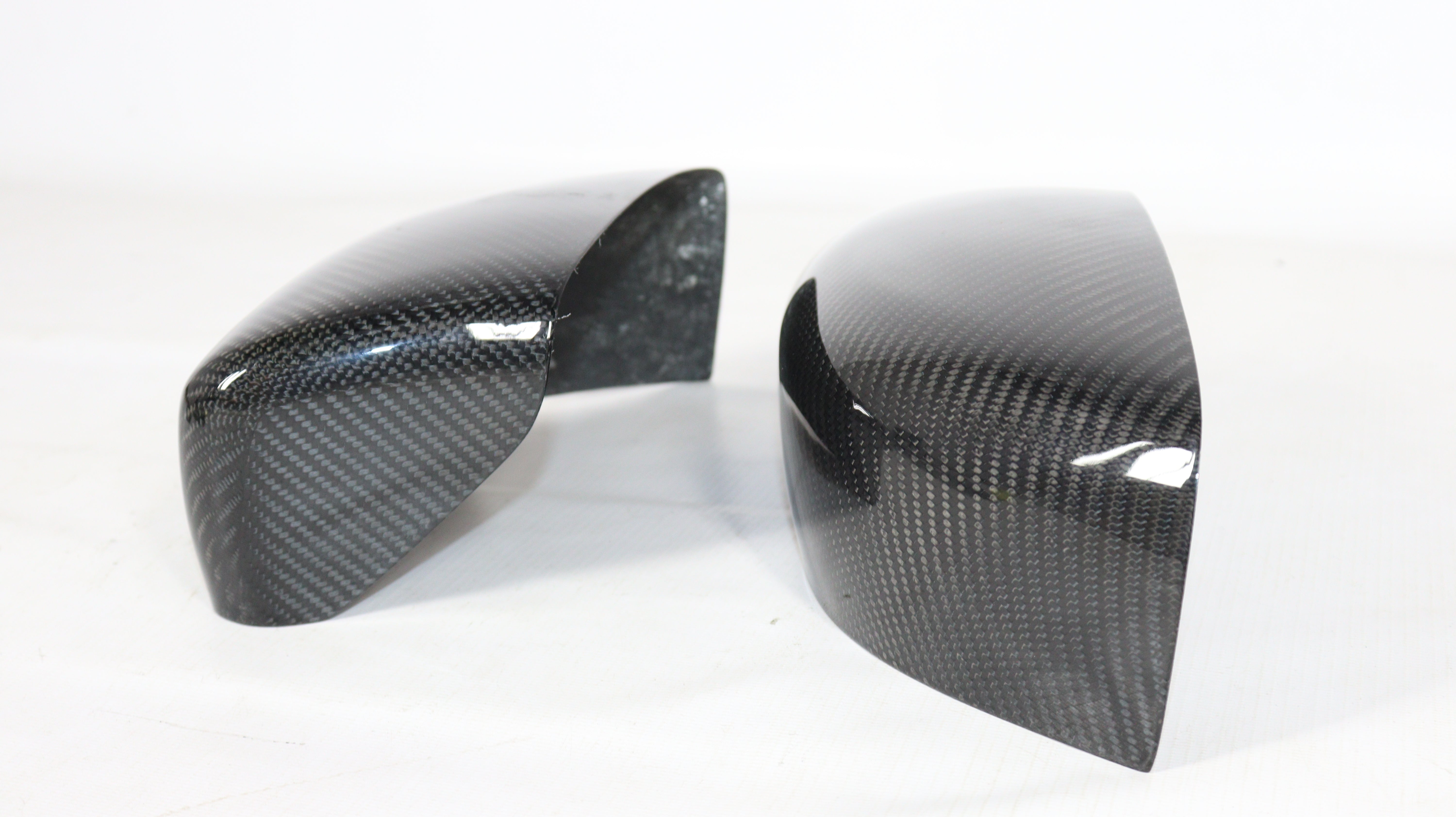 Carbon mirror covers for Maserati Quattroporte Ghibli 2013+ from Custom Class, featuring genuine carbon fiber with a high-gloss UV-resistant coating.