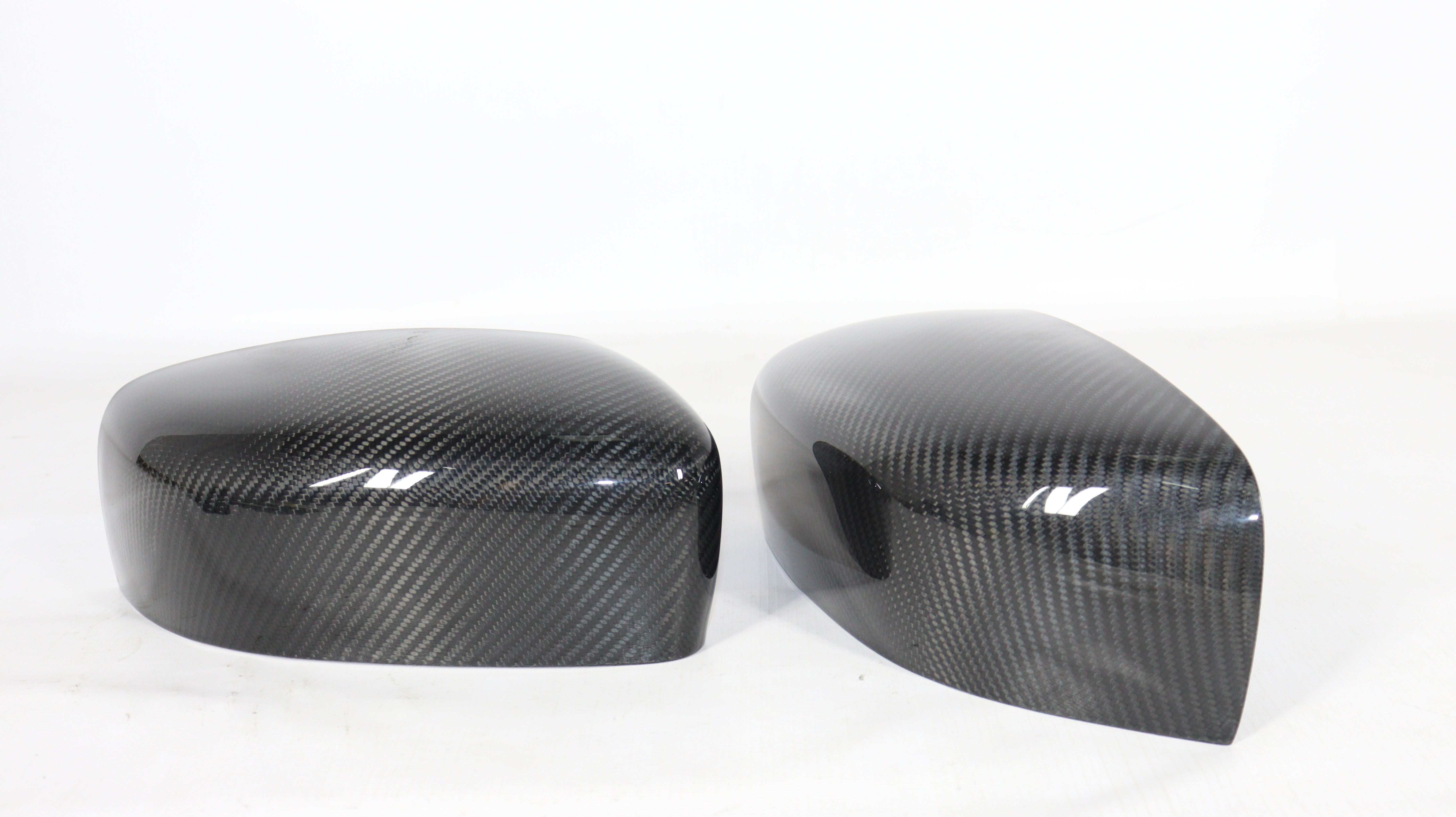 Carbon mirror covers for Maserati Quattroporte Ghibli 2013+ from Custom Class, featuring genuine carbon fiber with a high-gloss UV-resistant coating.