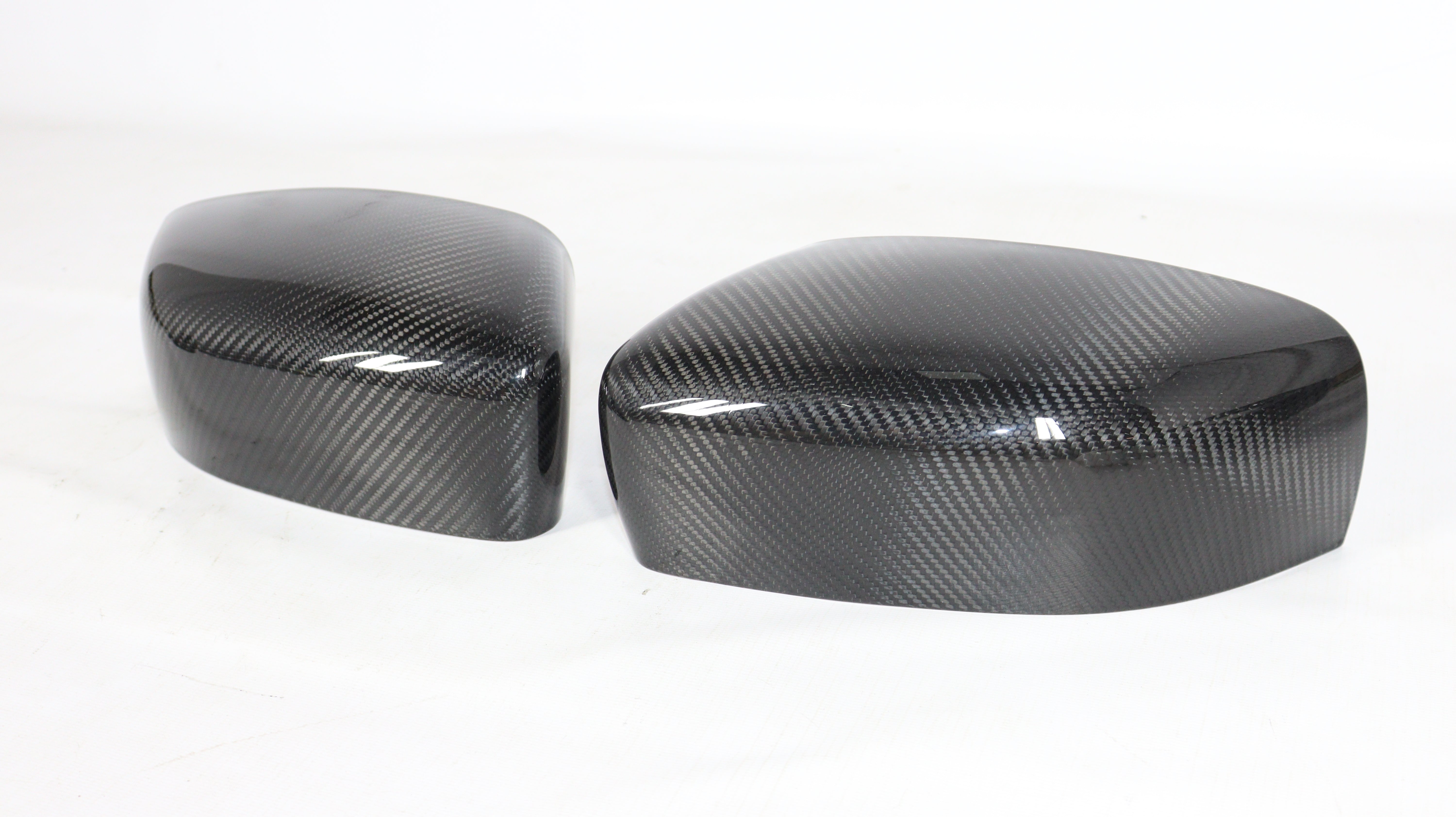 Carbon mirror covers for Maserati Quattroporte Ghibli 2013+ from Custom Class, featuring genuine carbon fiber with a high-gloss UV-resistant coating.