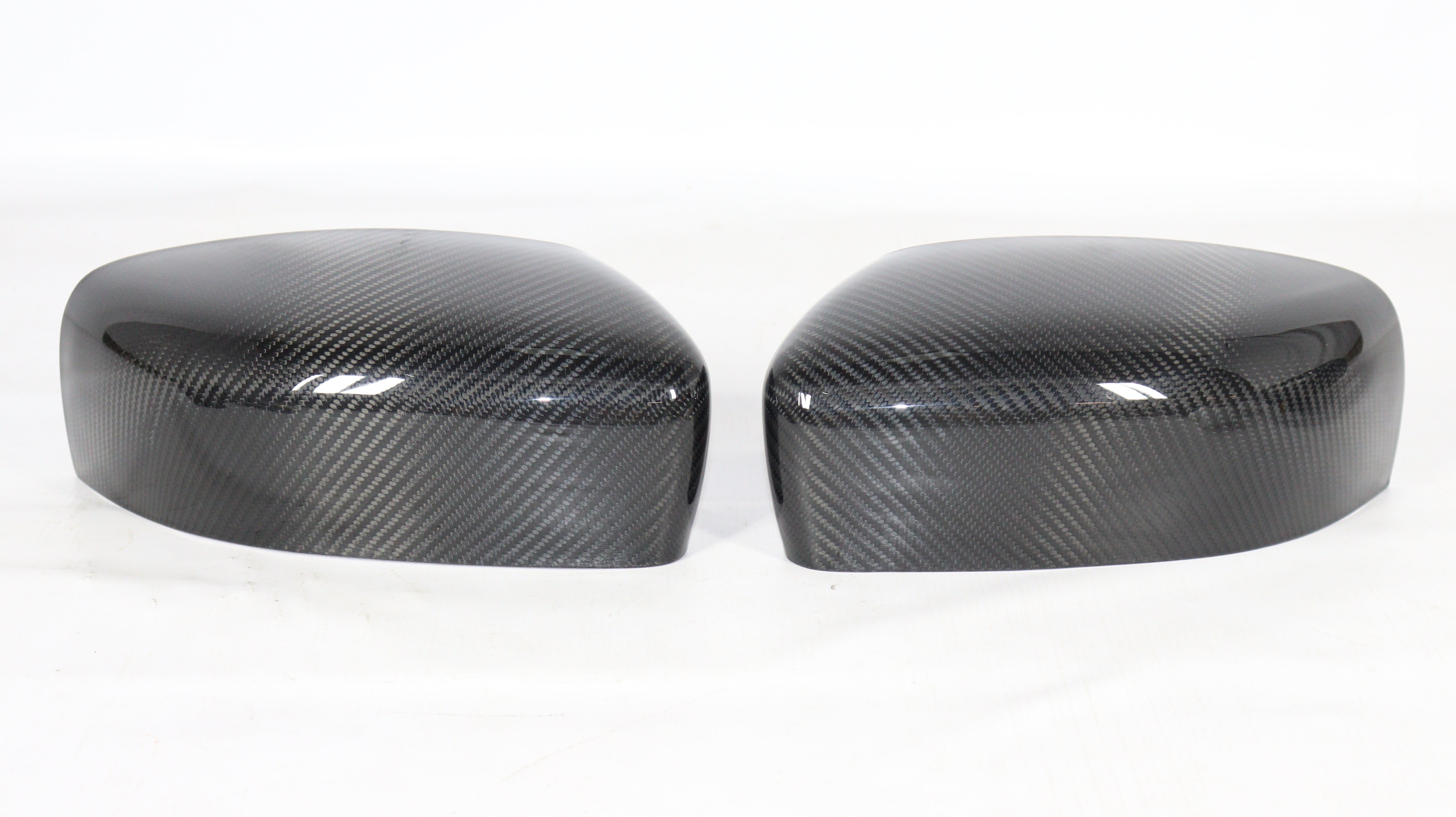 Carbon mirror covers for Maserati Quattroporte Ghibli 2013+ from Custom Class, featuring genuine carbon fiber with a high-gloss UV-resistant coating.