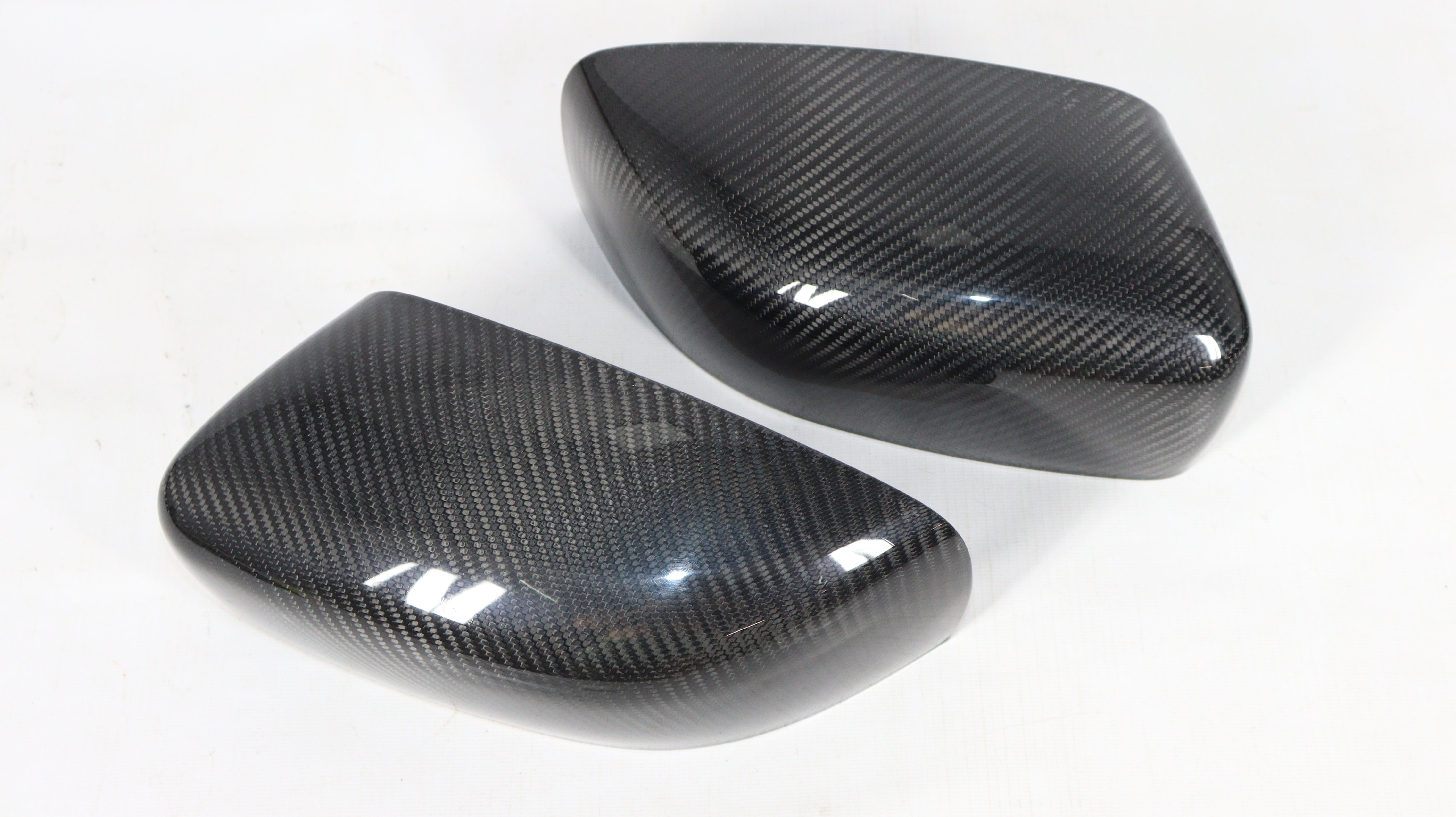 Carbon mirror covers for Maserati Quattroporte Ghibli 2013+ from Custom Class, featuring genuine carbon fiber with a high-gloss UV-resistant coating.