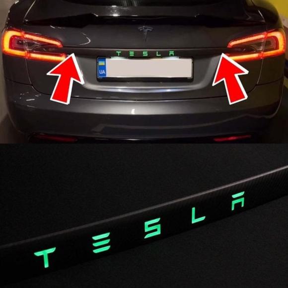 Carbon rear trunk trim with LEDs for Tesla Model S from Custom Class, made of genuine carbon fiber with a grey gloss UV-resistant coating.