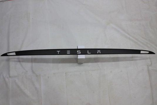 Carbon rear trunk trim with LEDs for Tesla Model S from Custom Class, made of genuine carbon fiber with a grey gloss UV-resistant coating.