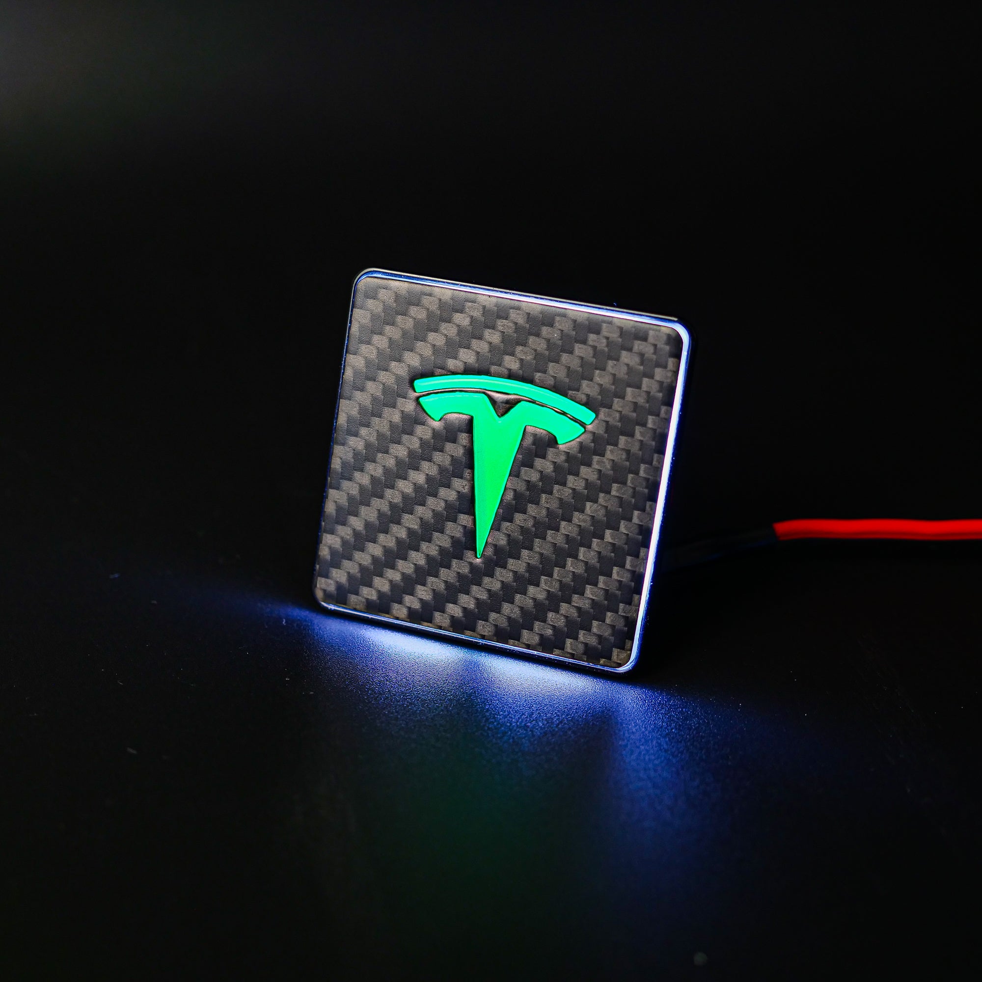 Carbon metal LED-illuminated seat emblems for Tesla Model S, Model 3, Model X, Model Y, and Cybertruck, available in customizable LED colors for front and rear seats.