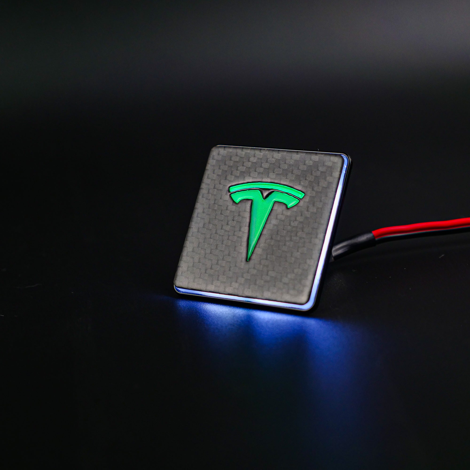 Carbon metal LED-illuminated seat emblems for Tesla Model S, Model 3, Model X, Model Y, and Cybertruck, available in customizable LED colors for front and rear seats.