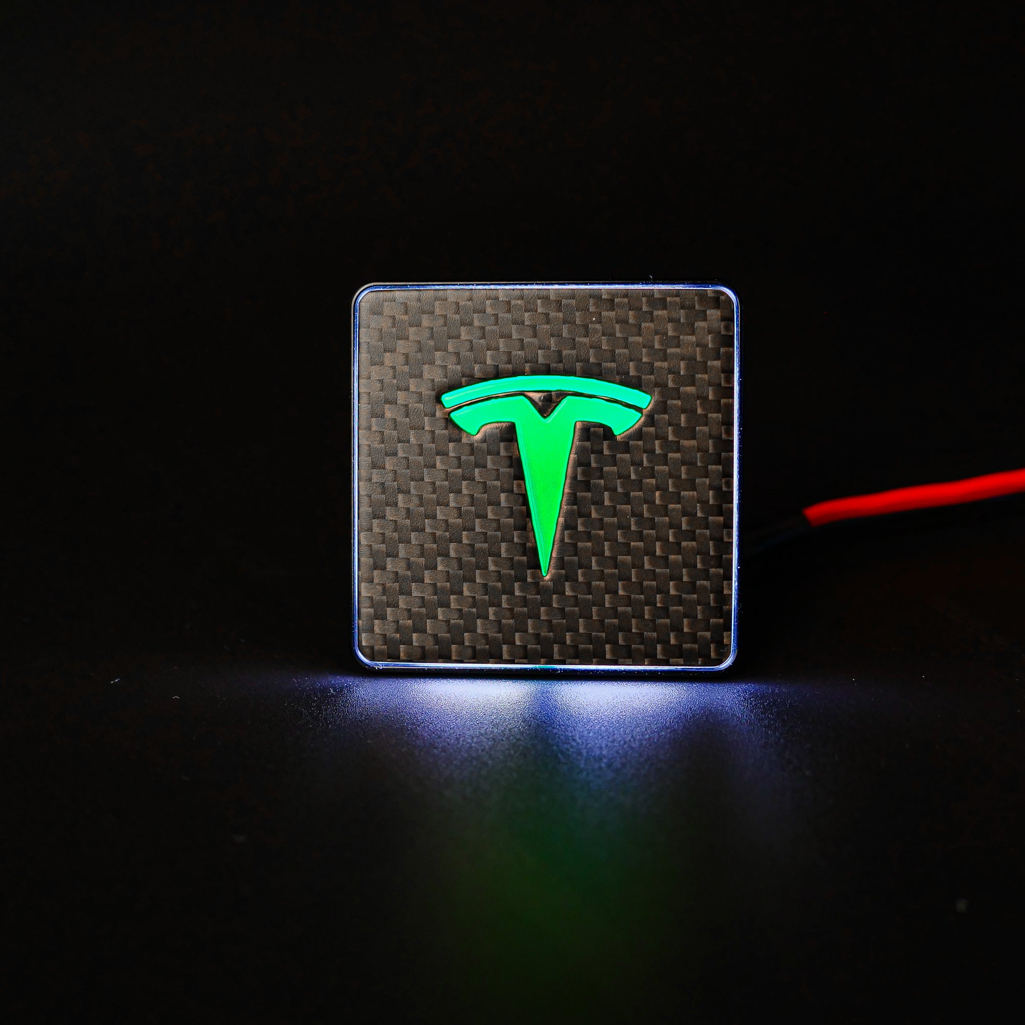 Carbon metal LED-illuminated seat emblems for Tesla Model S, Model 3, Model X, Model Y, and Cybertruck, available in customizable LED colors for front and rear seats.