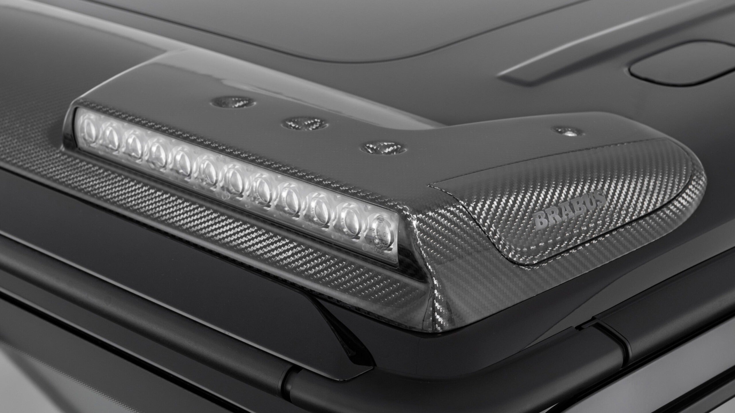 Brabus Front Roof Carbon Spoiler with LEDs for Mercedes-Benz G-Class W465 (2024+), premium carbon fiber construction.