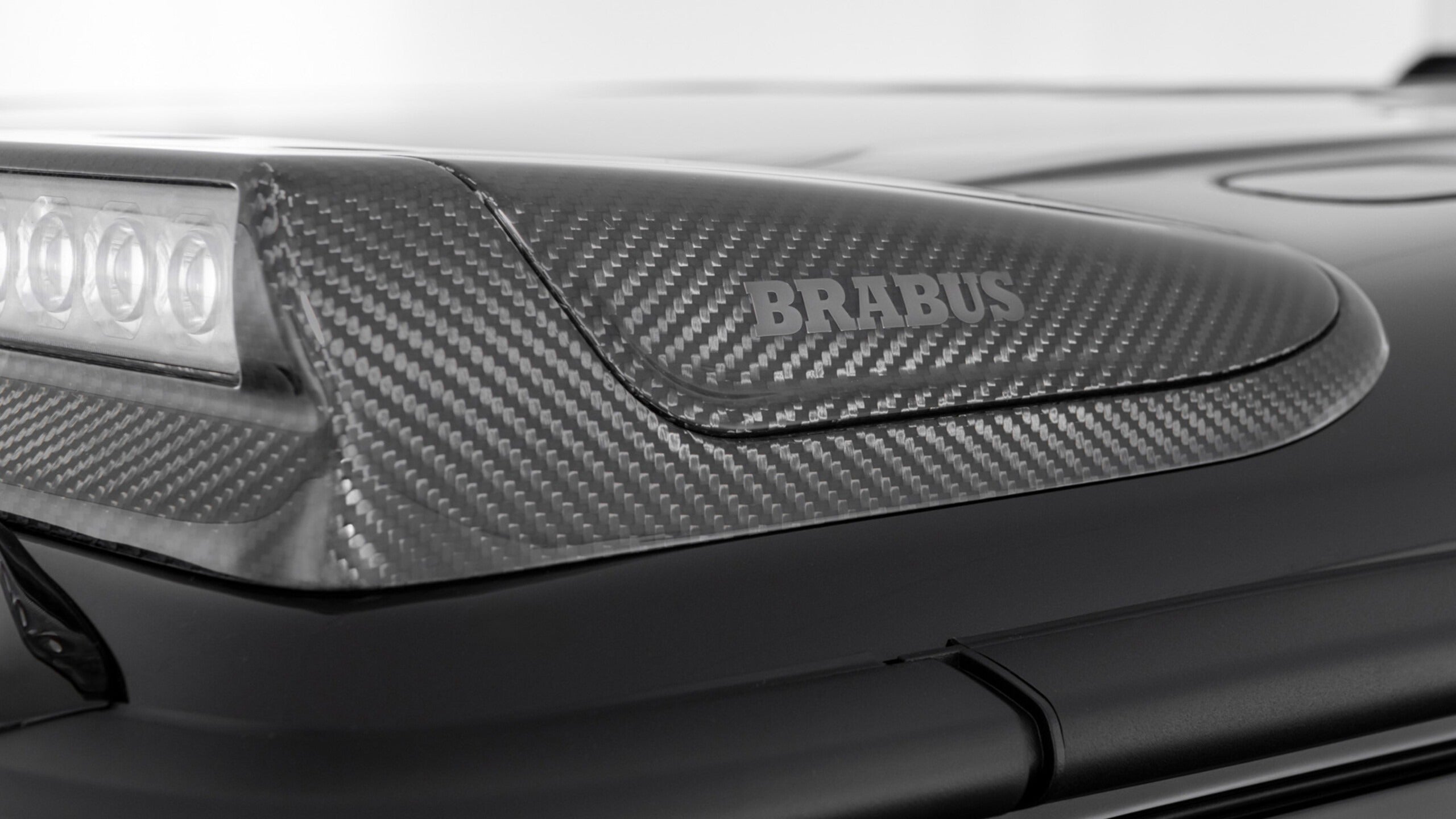 Brabus Front Roof Carbon Spoiler with LEDs for Mercedes-Benz G-Class W465 (2024+), premium carbon fiber construction.