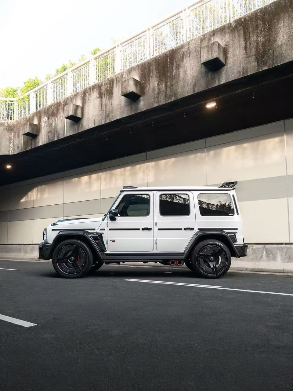 Full side profile view of a Mercedes-Benz G-Class W465 featuring the complete Rocket widebody package and carbon fiber side moldings.