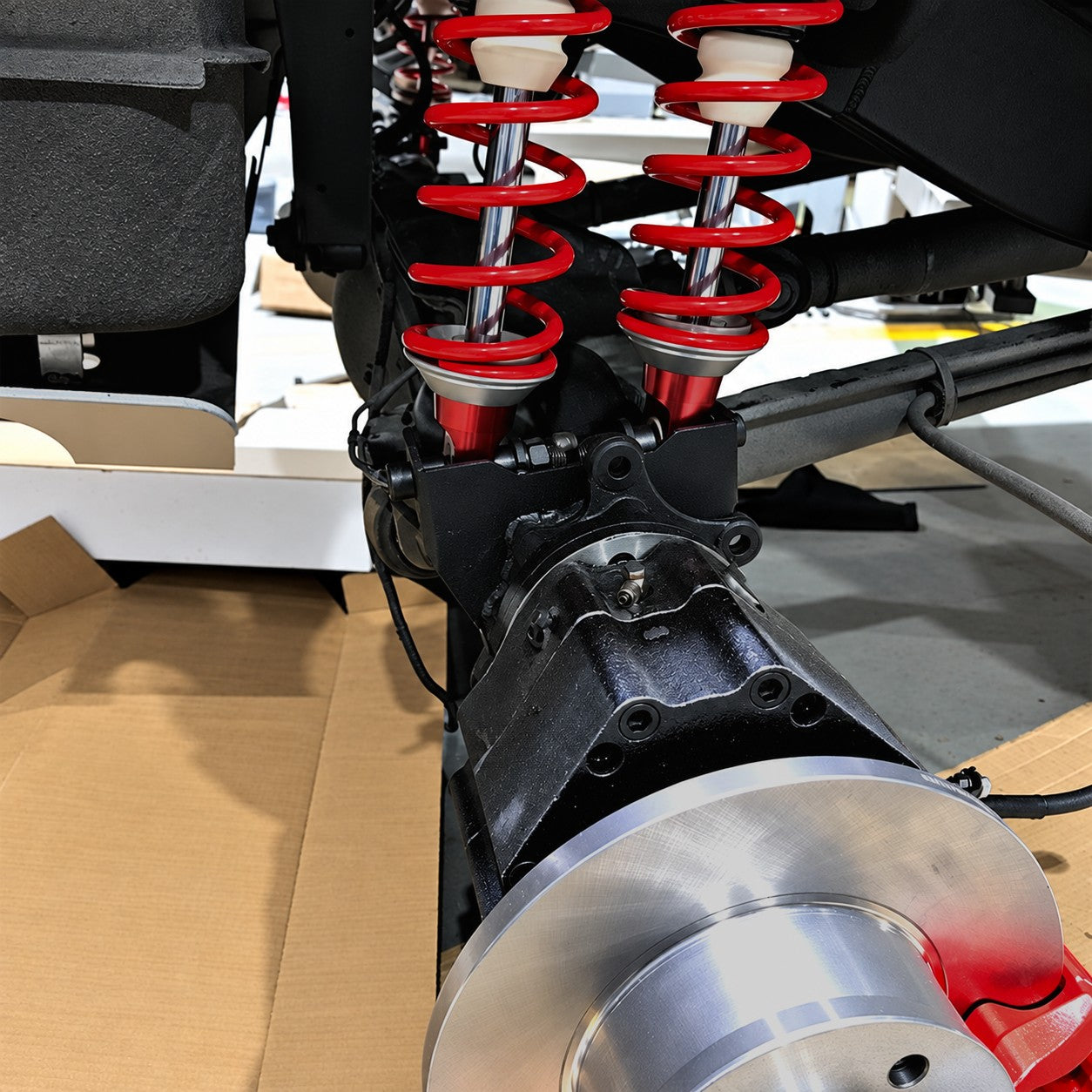 Reinforced steel frame mounting brackets and shock hoops for W463 dual shock axle conversion by Custom Class.