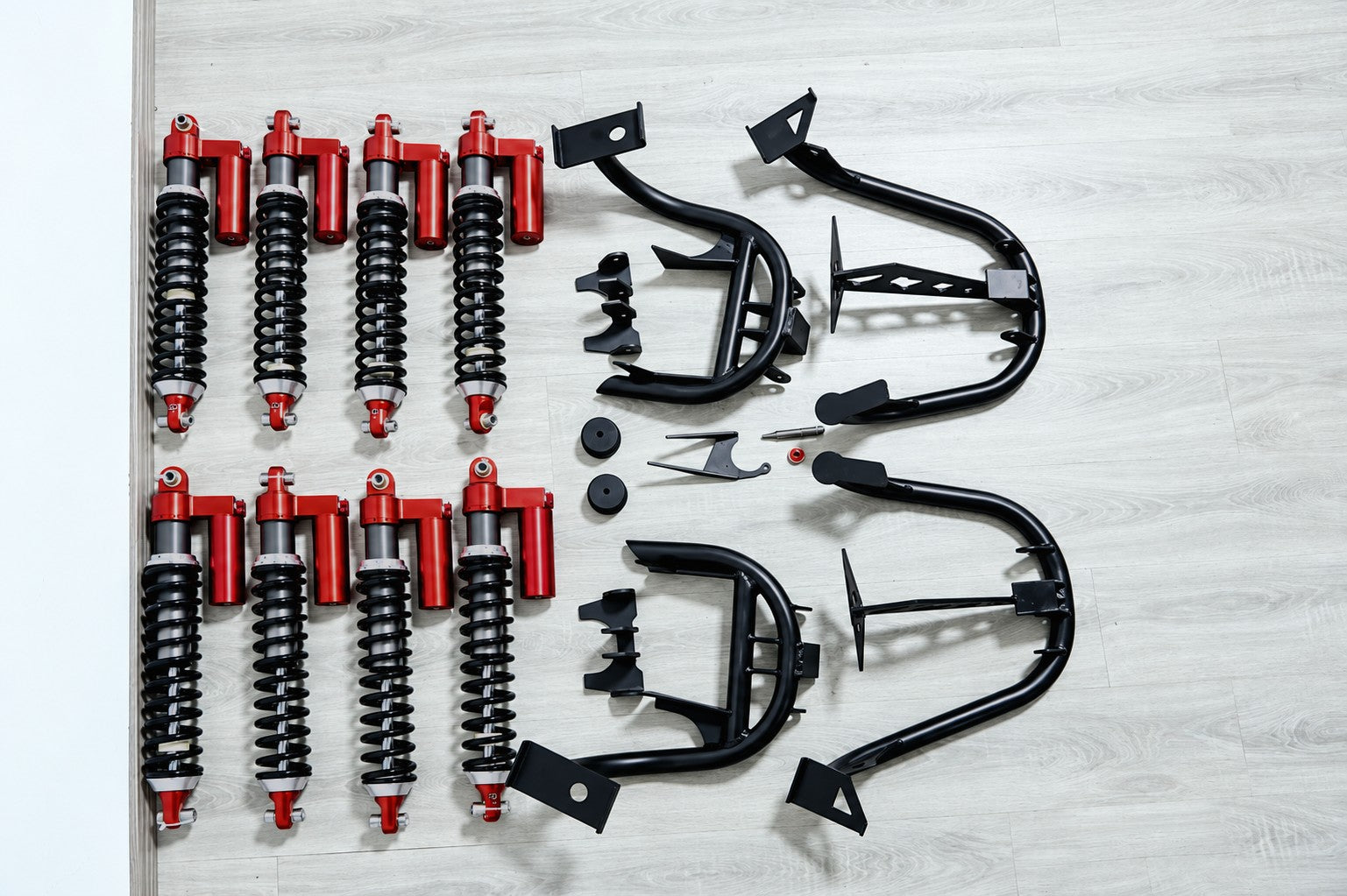 Layout of heavy-duty dual shocks, tubular brackets, and mounting hardware for Mercedes-Benz G-Wagon W463 suspension upgrade.