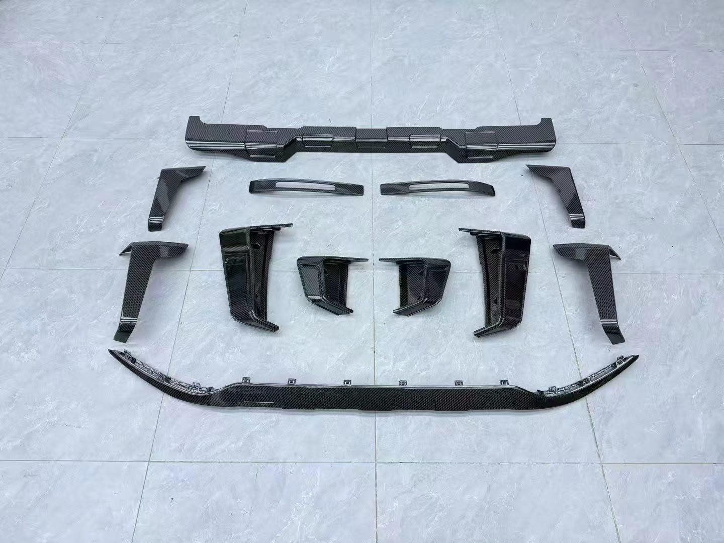 Rear bumper Widestar-style carbon fiber inserts and diffuser trim add-ons for G-Wagon W465.