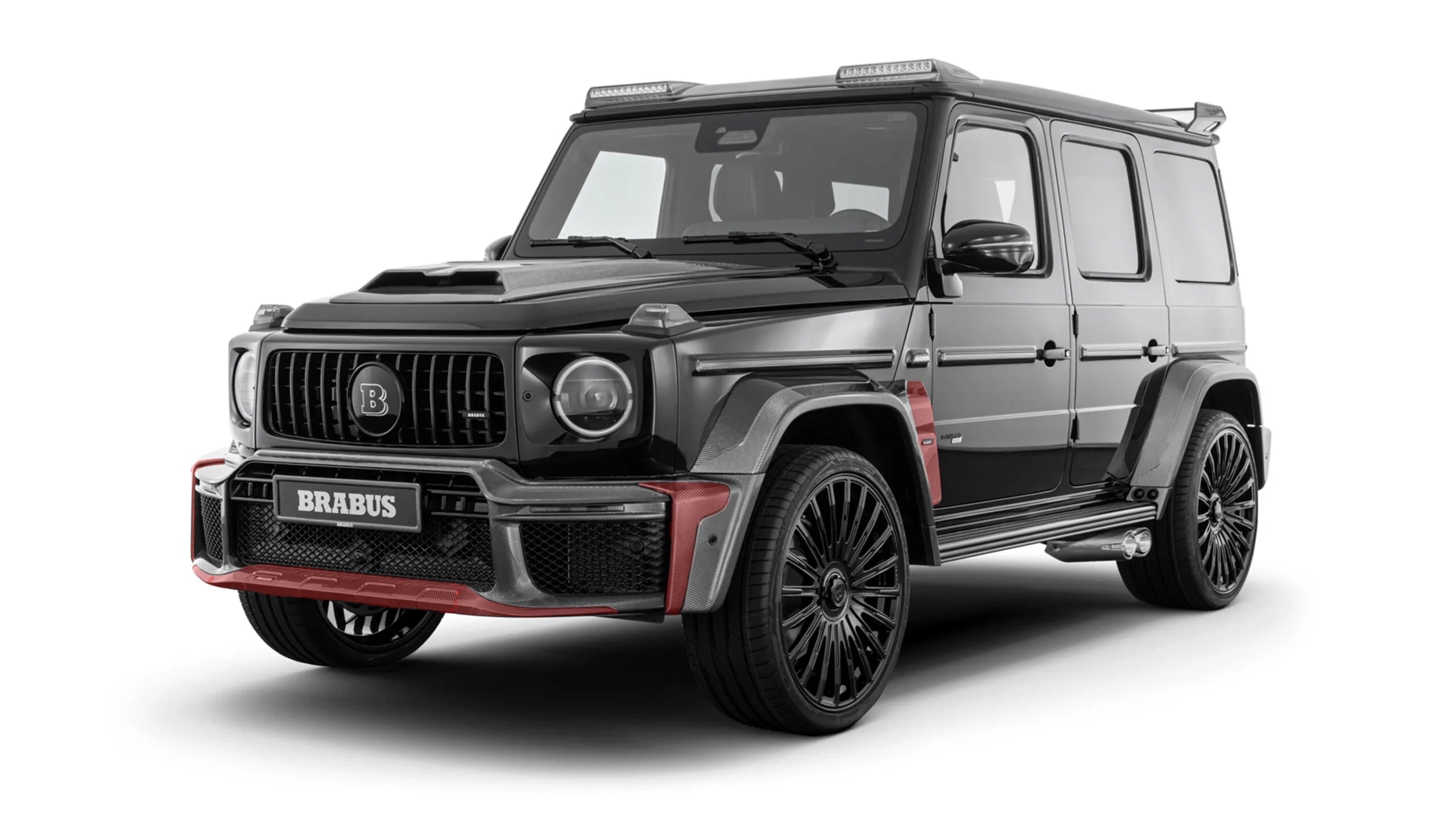 Exterior view of a black W465 G-Class showcasing Custom Class carbon fiber bumper inserts and fender flares.