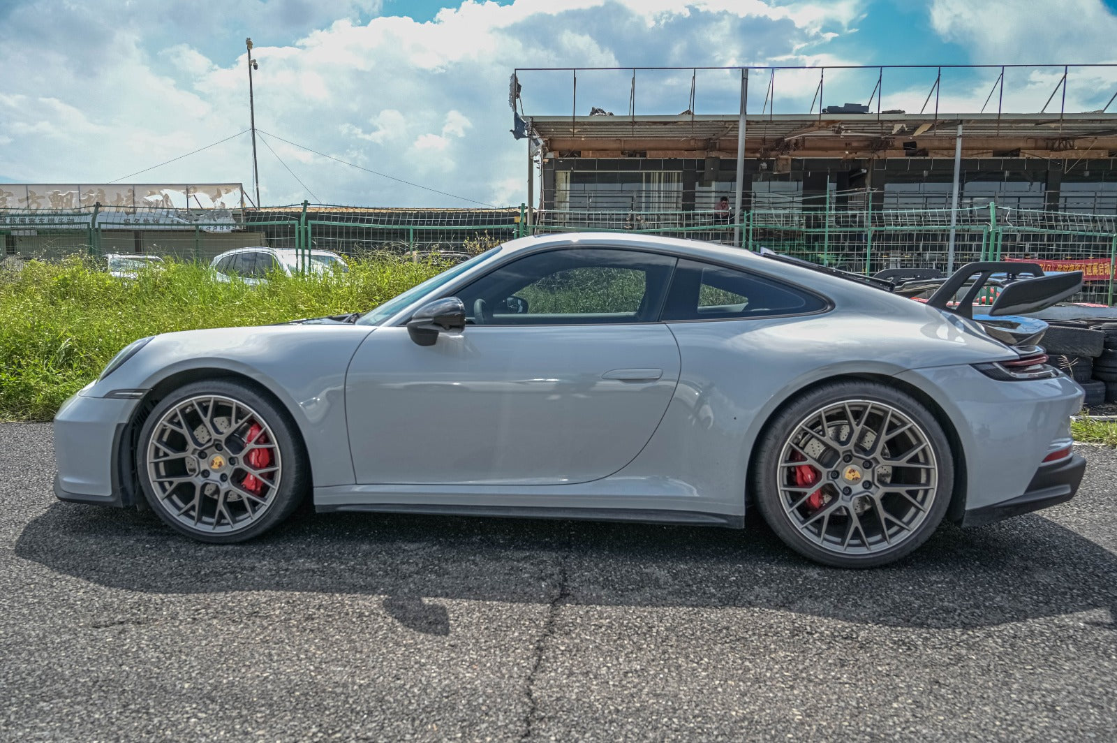 GT3 body kit side profile for Porsche 911 992 showing aggressive stance and racing aesthetics