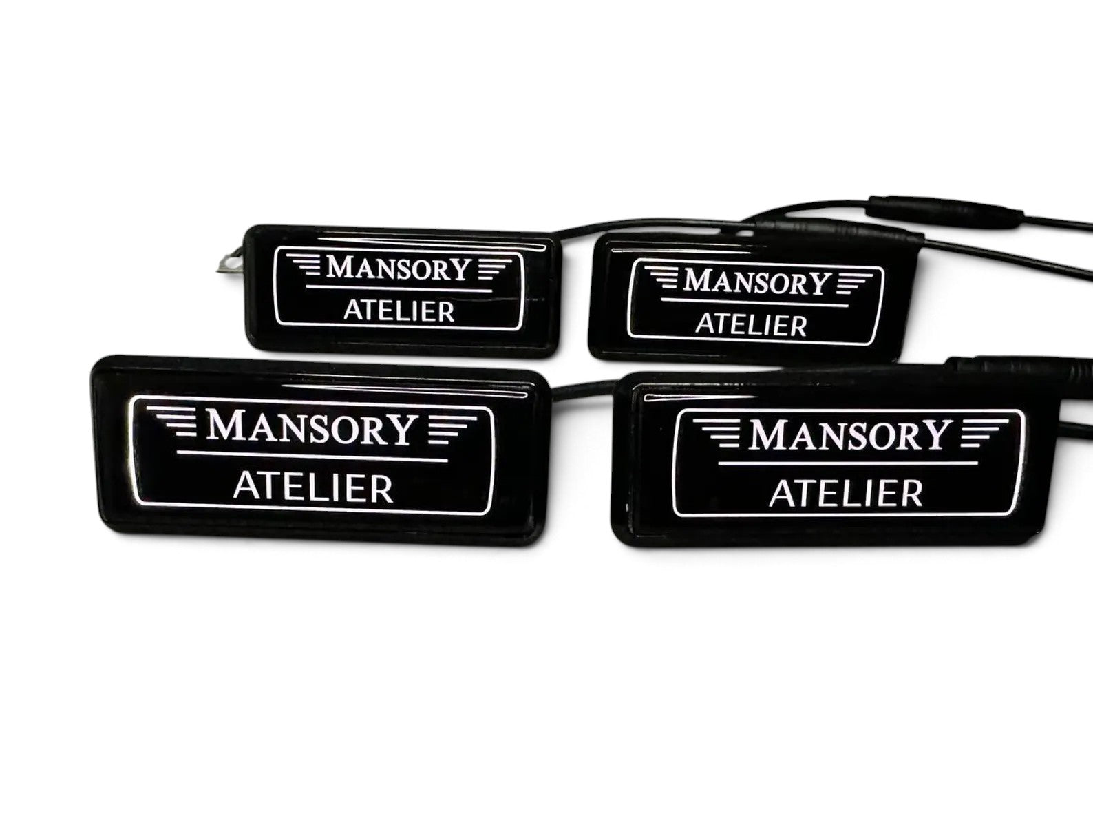 Close-up of Custom Class metal LED seat badges with wiring harness for ambient lighting