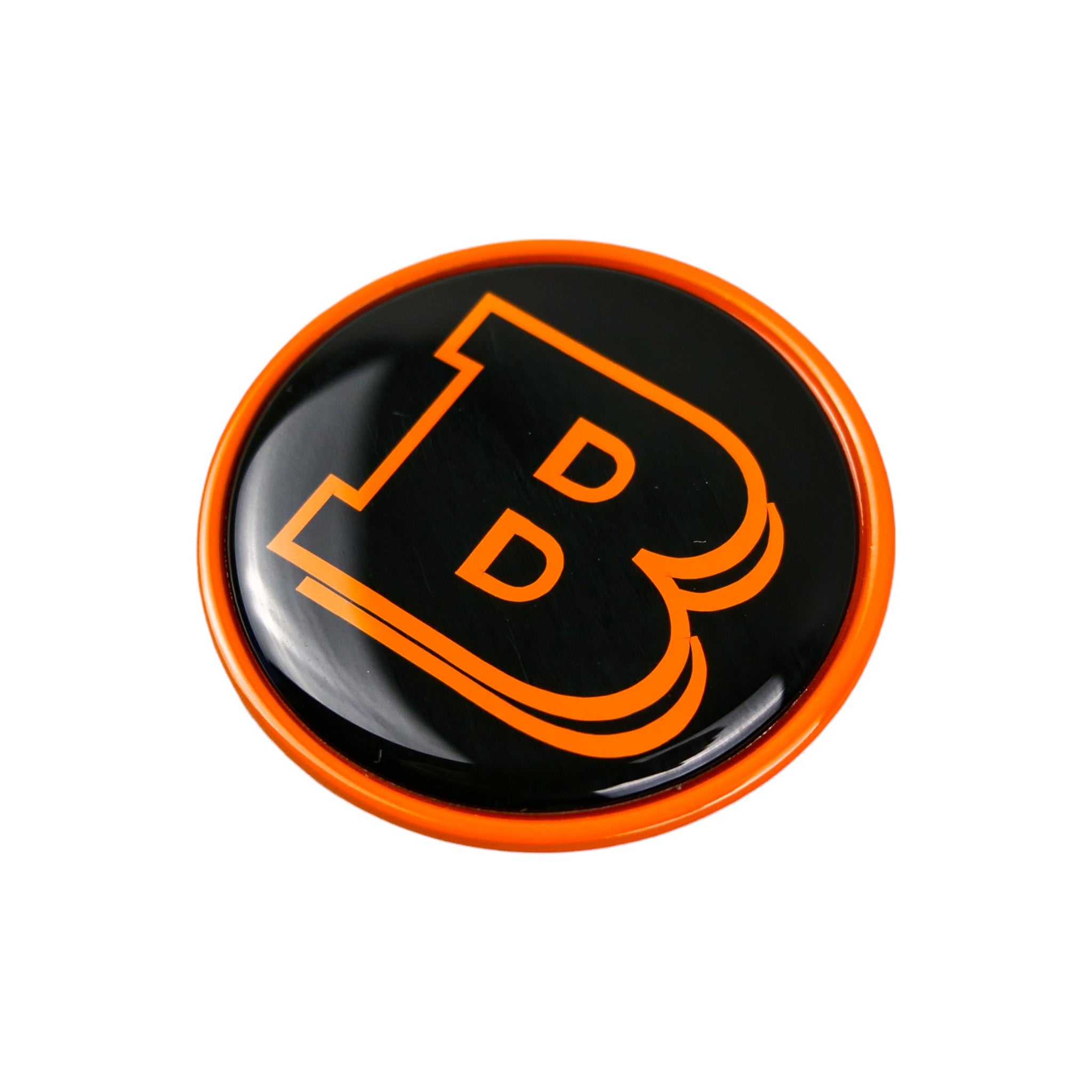 Metal orange Brabus badge logo emblem 55mm for hood scoop of Mercedes G-Class W463, W463A from Custom Class, featuring a two-component metal design with orange and black accents.