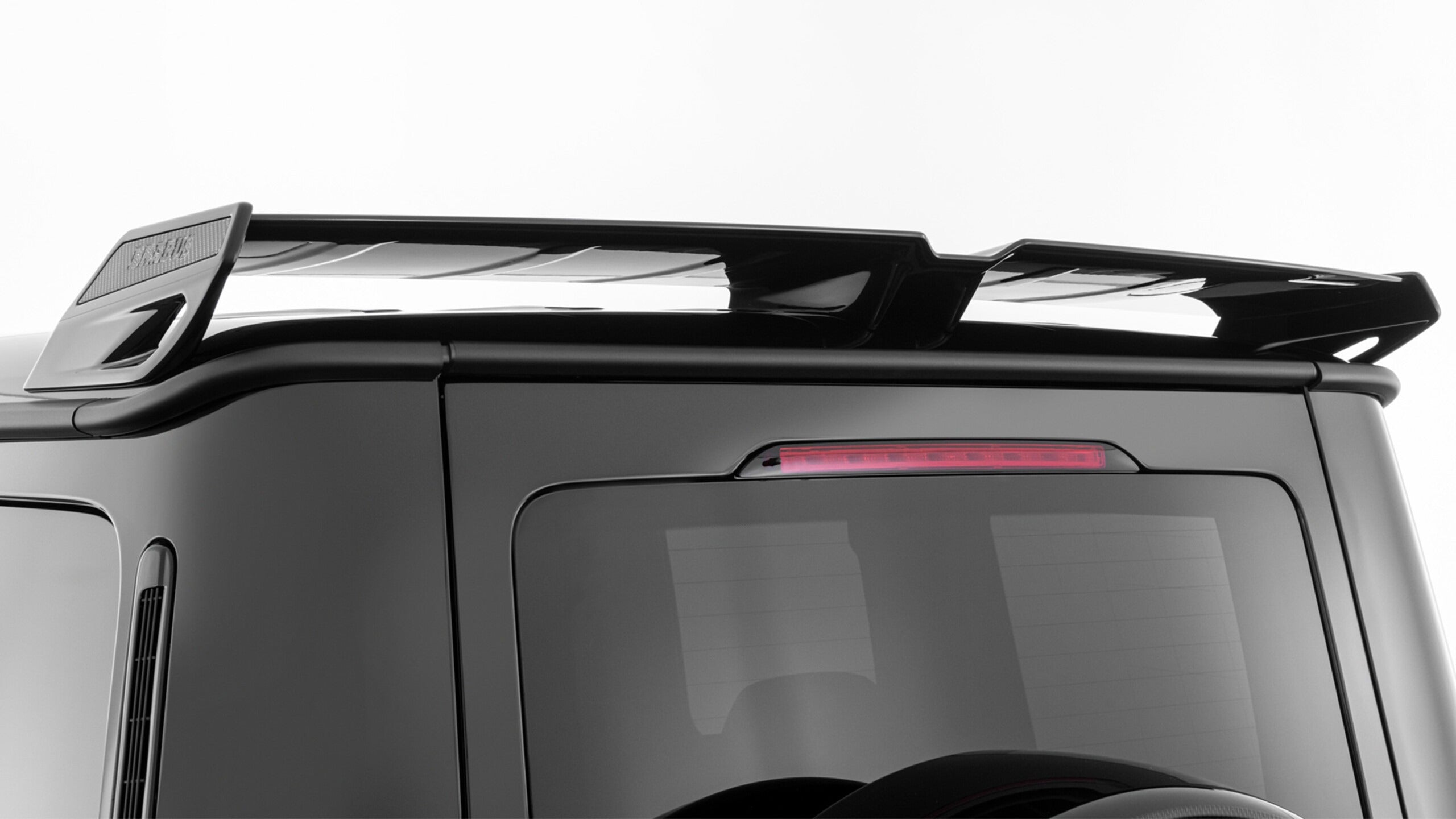 Brabus Rear Roof Spoiler with Carbon Inserts for Mercedes-Benz G-Class W465 (2024+), high-quality fiberglass with carbon accents.