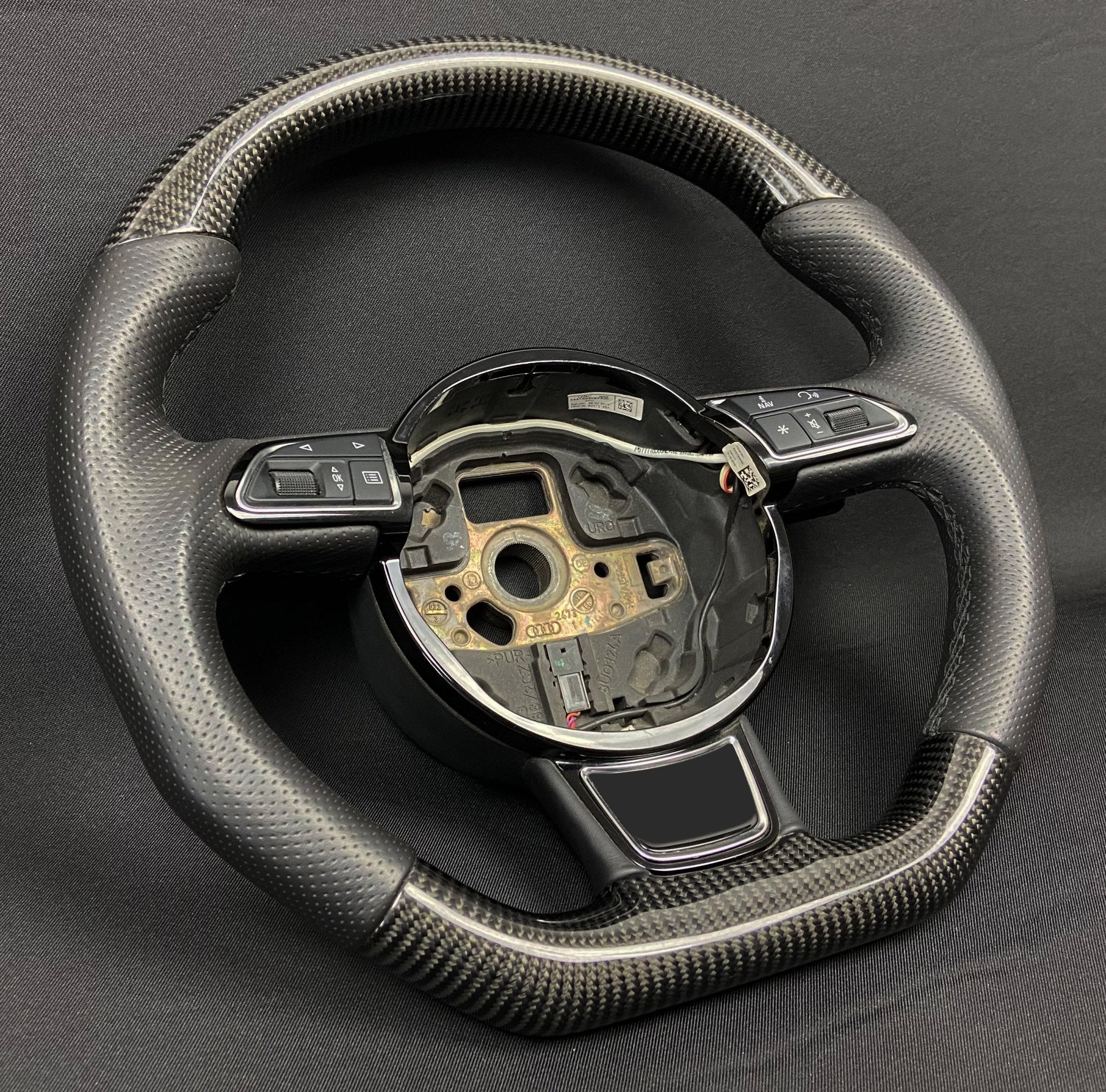 OEM remanufactured Audi A6 A7 A8 steering wheel with carbon fiber, perforated black leather, flat bottom, and stock paddle shifts from Custom Class.