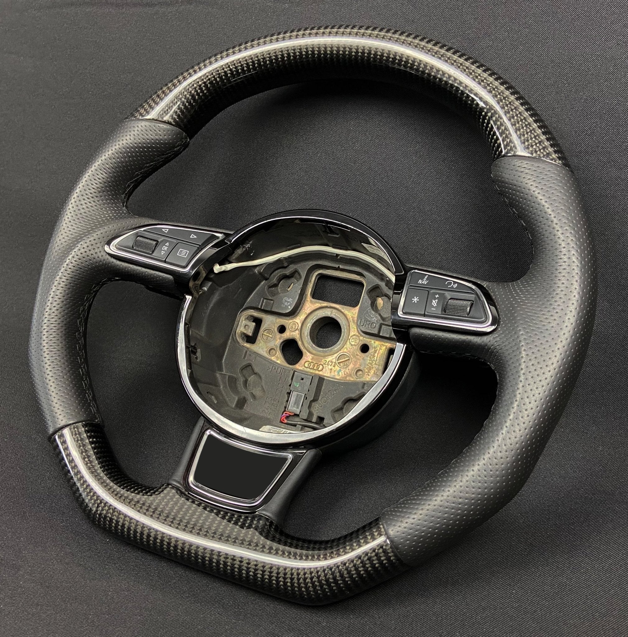 OEM remanufactured Audi A6 A7 A8 steering wheel with carbon fiber, perforated black leather, flat bottom, and stock paddle shifts from Custom Class.