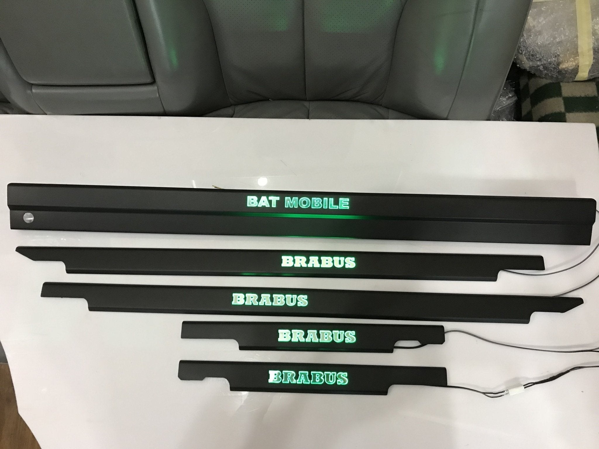 Bat Mobile Brabus style LED illuminated door sills, 4 or 5 pcs, for Mercedes-Benz G-Class W463 from Custom Class, featuring stainless steel construction and blue or orange sign colors.