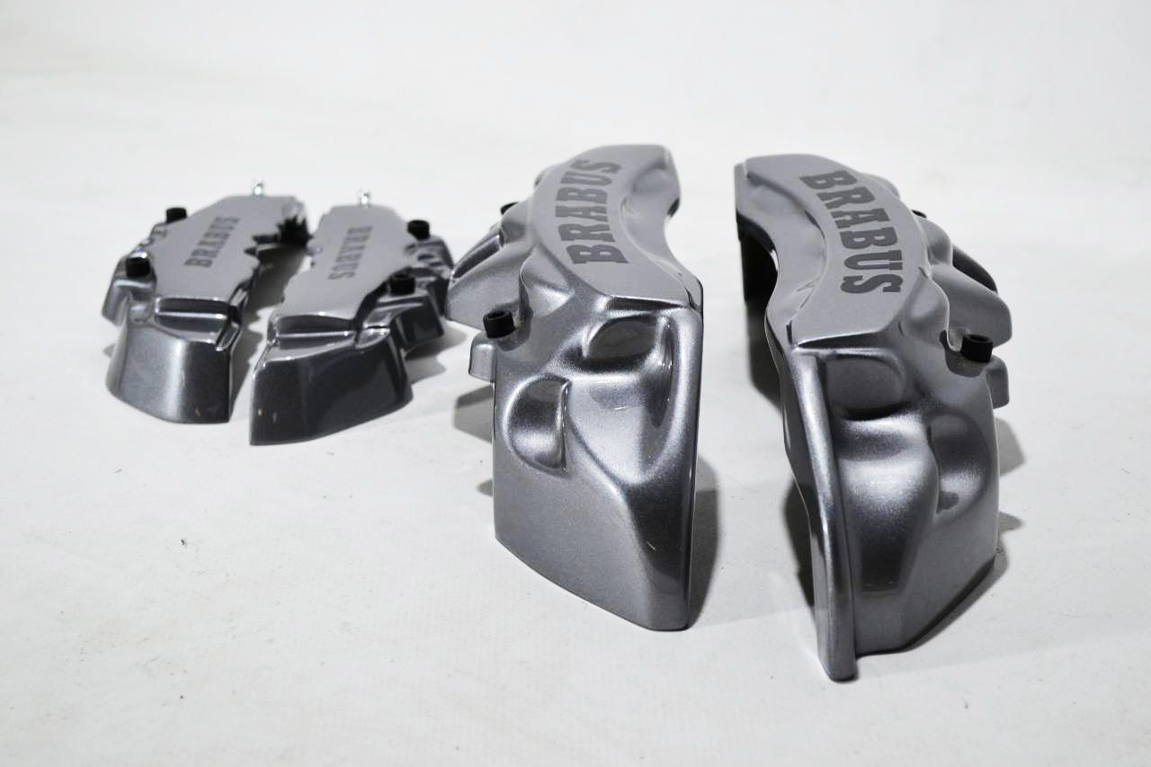 Brabus grey disc caliper covers, 4-piece set for Mercedes-Benz G-Wagon W463 from Custom Class, offering sleek and sporty decorative styling.